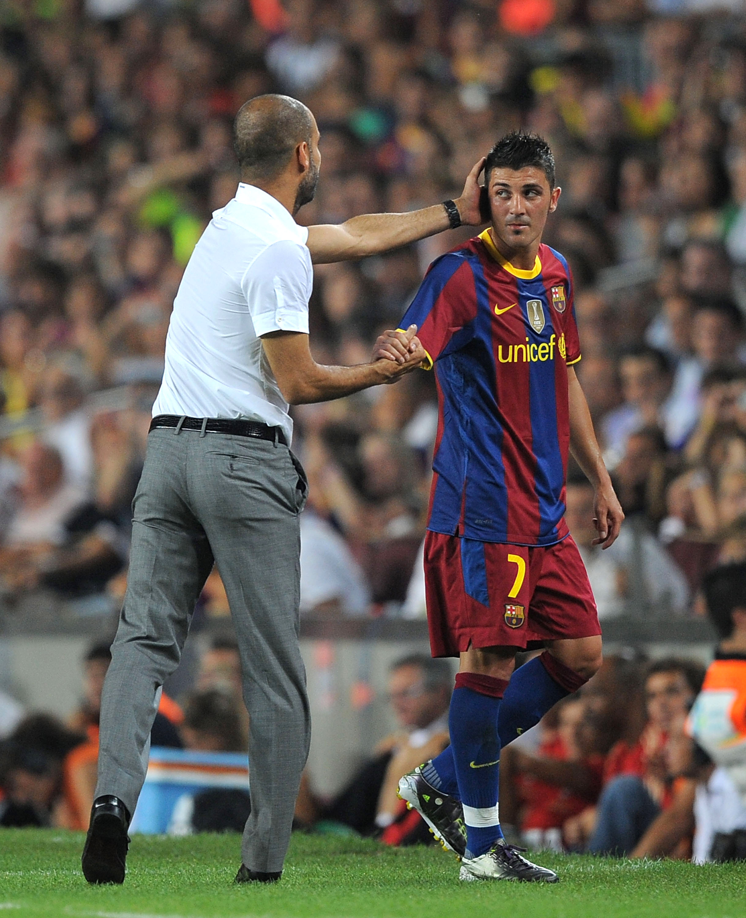 BARCELONA, SPAIN - AUGUST 25:  David Villa of Barcelona is congratulated by Barcelona manager Josep Guardiola after he was substituted during the Joan Gamper Trophy match between Barcelona and AC Milan at Camp Nou stadium on August 25, 2010 in Barcelona, 