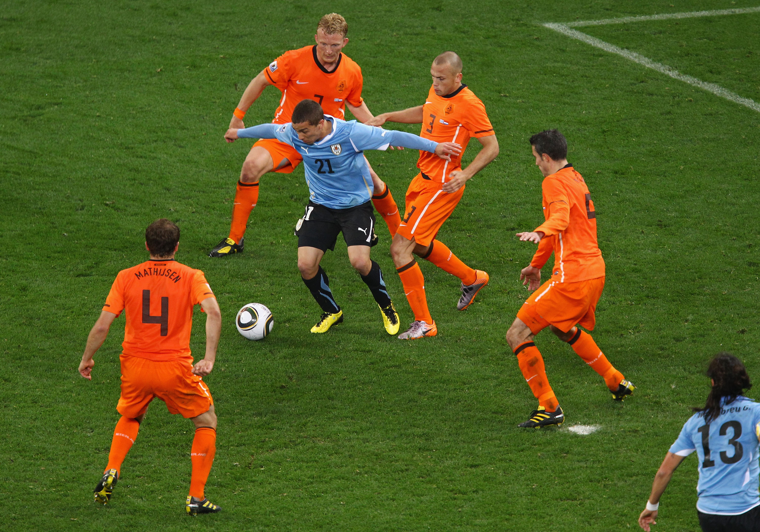 CAPE TOWN, SOUTH AFRICA - JULY 06: Sebastian Fernandez of Uruguay is challenged by the Netherlands defence during the 2010 FIFA World Cup South Africa Semi Final match between Uruguay and the Netherlands at Green Point Stadium on July 6, 2010 in Cape Town