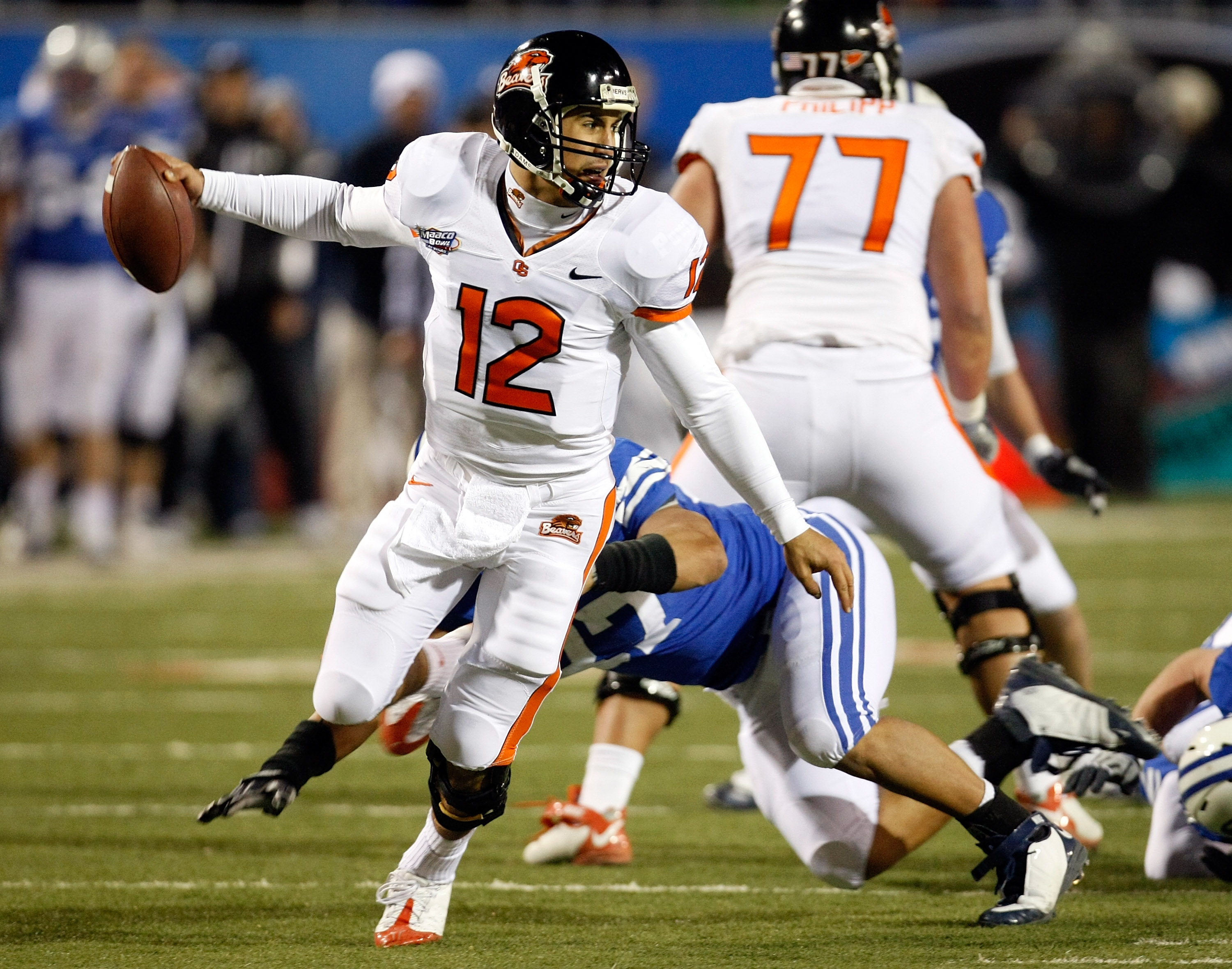 LAS VEGAS - DECEMBER 22: Quarterback Ryan Katz #12 of the Oregon State Beavers scrambles away from Vic So'oto #37 of the Brigham Young University Cougars during the MAACO Las Vegas Bowl at Sam Boyd Stadium December 22, 2009 in Las Vegas, Nevada. The Coug