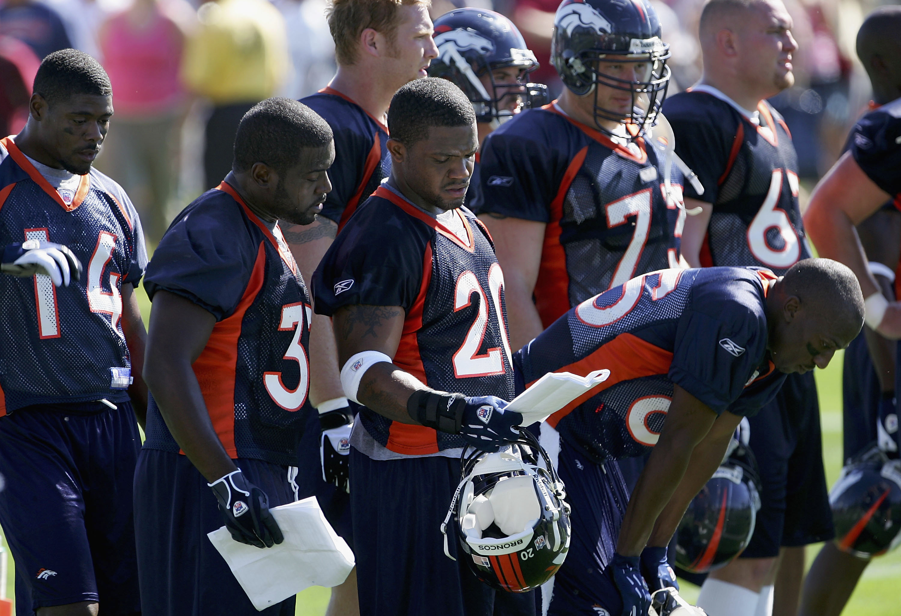 Running back Maurice Clarett smiles as he holds up a Denver