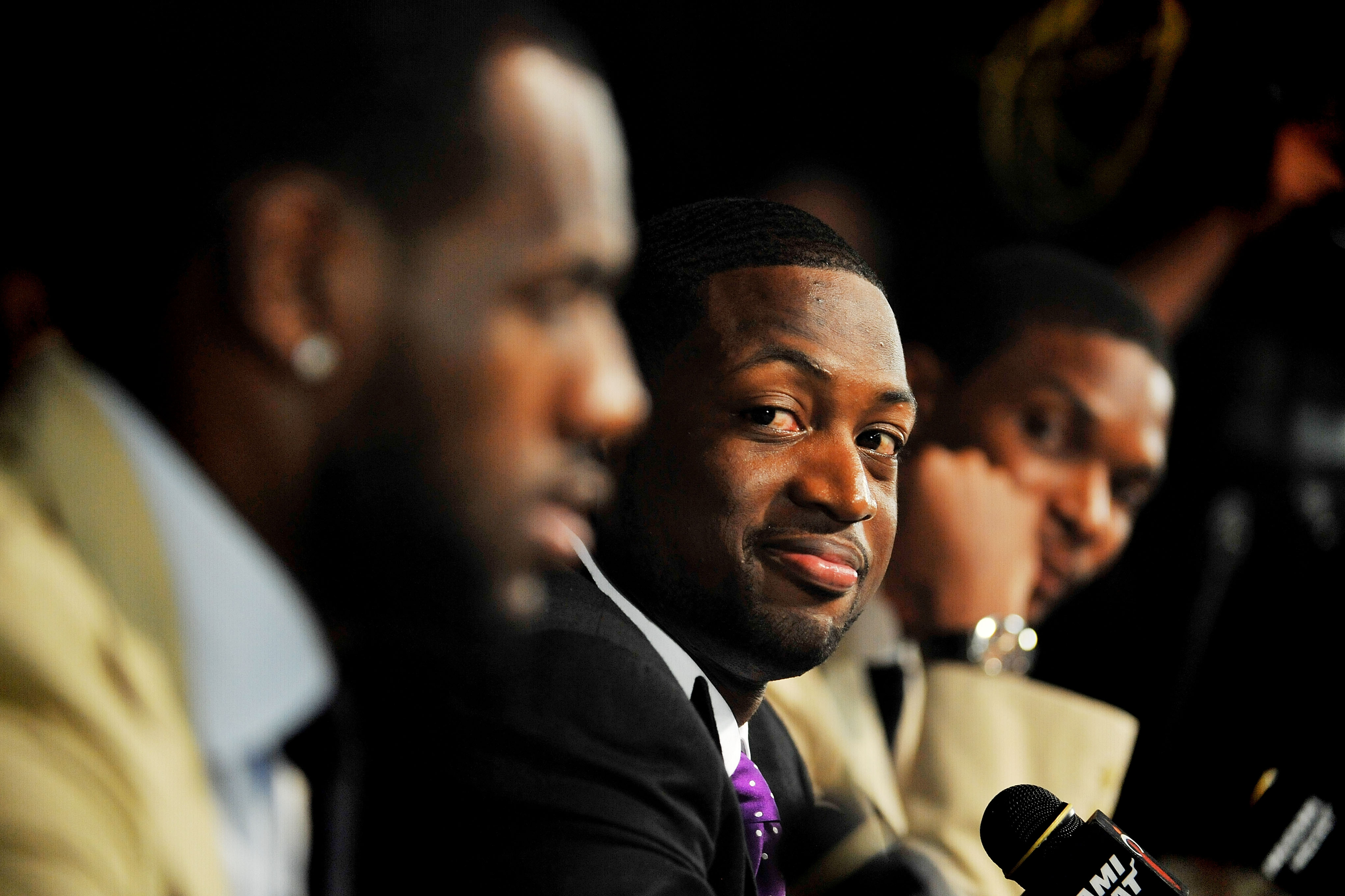 MIAMI - JULY 09:  Dwyane Wade #3 (C) of the Miami Heat talks during a press conference after a welcome party at American Airlines Arena on July 9, 2010 in Miami, Florida.  (Photo by Doug Benc/Getty Images)