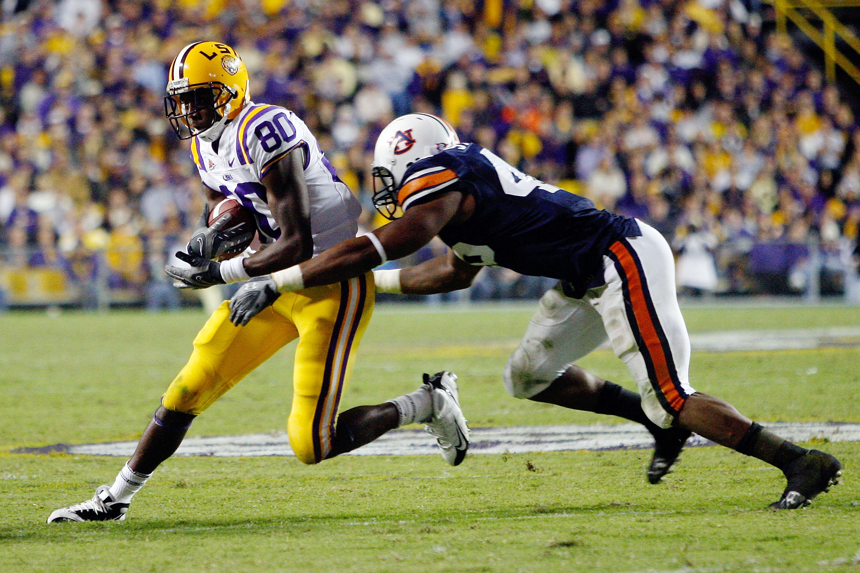 BATON ROUGE, LA - OCTOBER 24: Terrance Toliver #80 of the Louisiana State University Tigers is tackled by Antoine Carter #45 of the Auburn Tigers at Tiger Stadium on October 24, 2009 in Baton Rouge, Louisiana. (Photo by Chris Graythen/Getty Images)