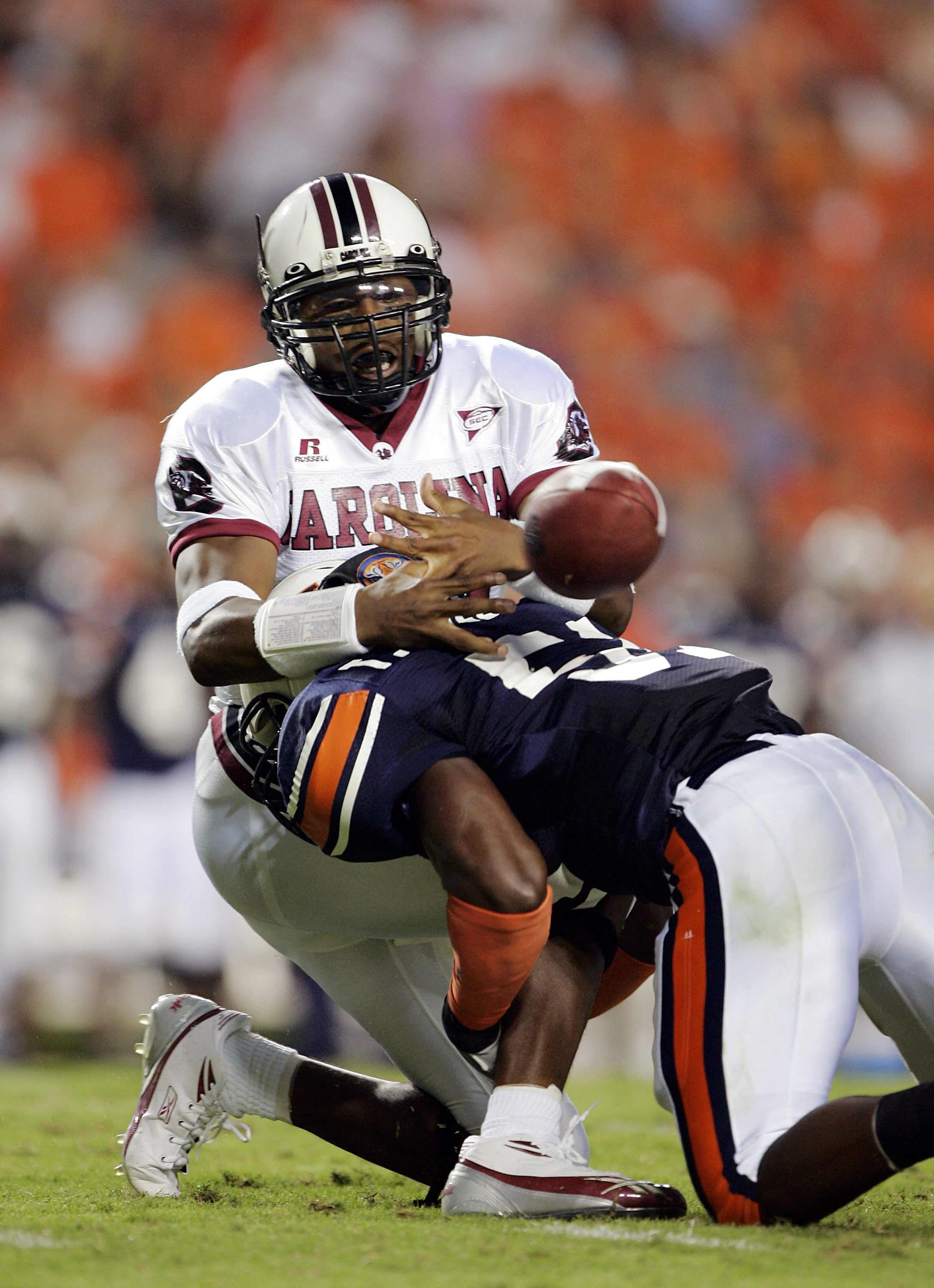 AUBURN, AL - OCTOBER 1: Redshirt freshman quarterback Antonio Heffner #18 of the South Carolina Gamecocks fumbles the ball for a turnover as he is hit by linebacker Travis Williams #51 of the Auburn Tigers in the first quarter on October 1, 2005 at Jorda