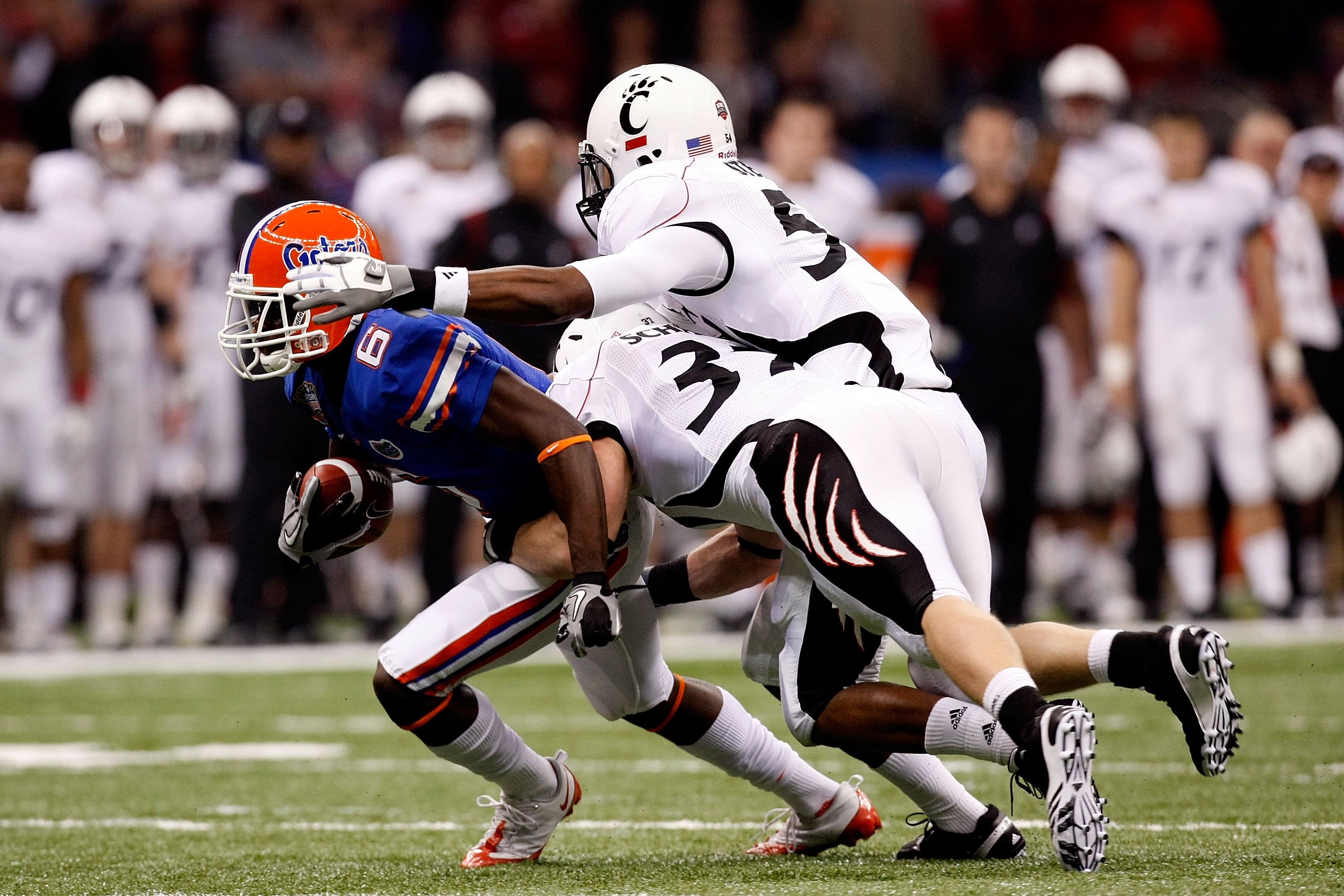 NEW ORLEANS - JANUARY 01: Deonte Thompson #6 of the Florida Gators gets tackled by J.K. Schaffer #37 of the Cincinnati Bearcats during the Allstate Sugar Bowl at the Louisana Superdome on January 1, 2010 in New Orleans, Louisiana. (Photo by Kevin C. Cox