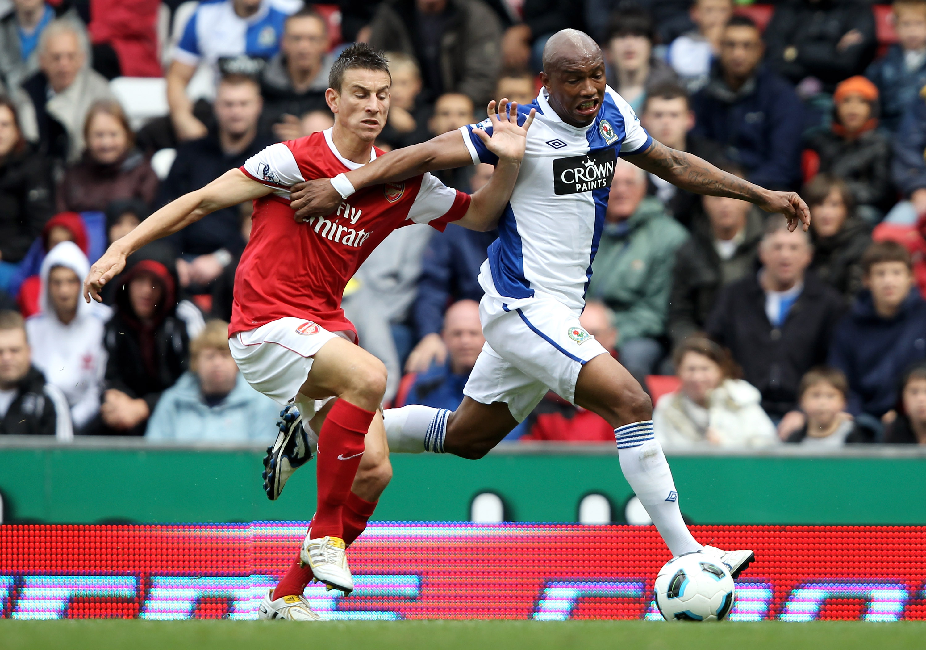 BLACKBURN, ENGLAND - AUGUST 28:  Laurent Koscielny of Arsenal tussles for posession with El Hadji Diouf of Blackburn Rovers during the Barclays Premier League match between Blackburn Rovers and Arsenal at Ewood Park on August 28, 2010 in Blackburn, Englan