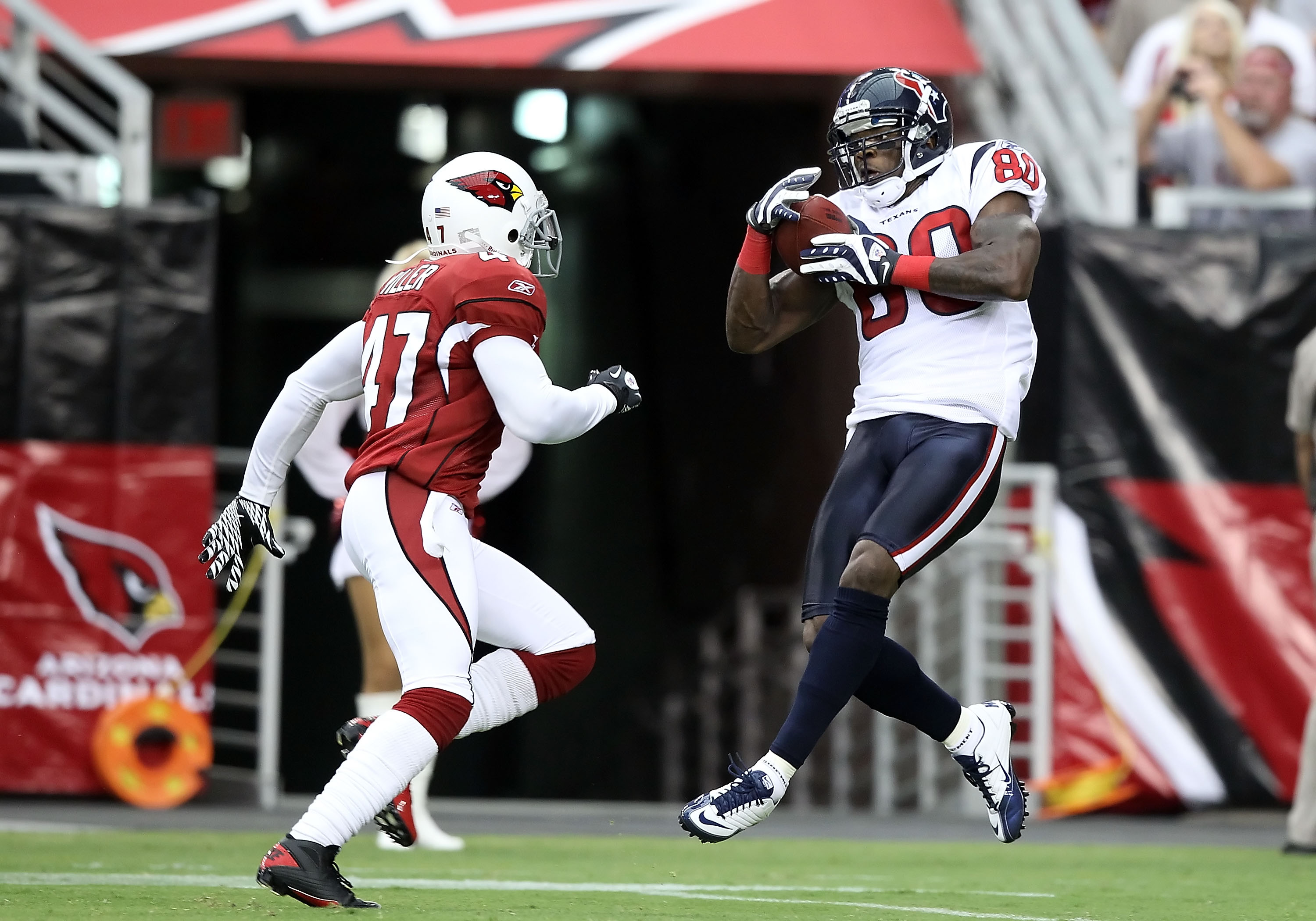 GLENDALE, AZ - AUGUST 14:  Wide receiver Andre Johnson #80 of the Houston Texans catches a 44 yard touchdown reception past Justin Miller #47 of the Arizona Cardinals during preseason NFL game at the University of Phoenix Stadium on August 14, 2010 in Gle