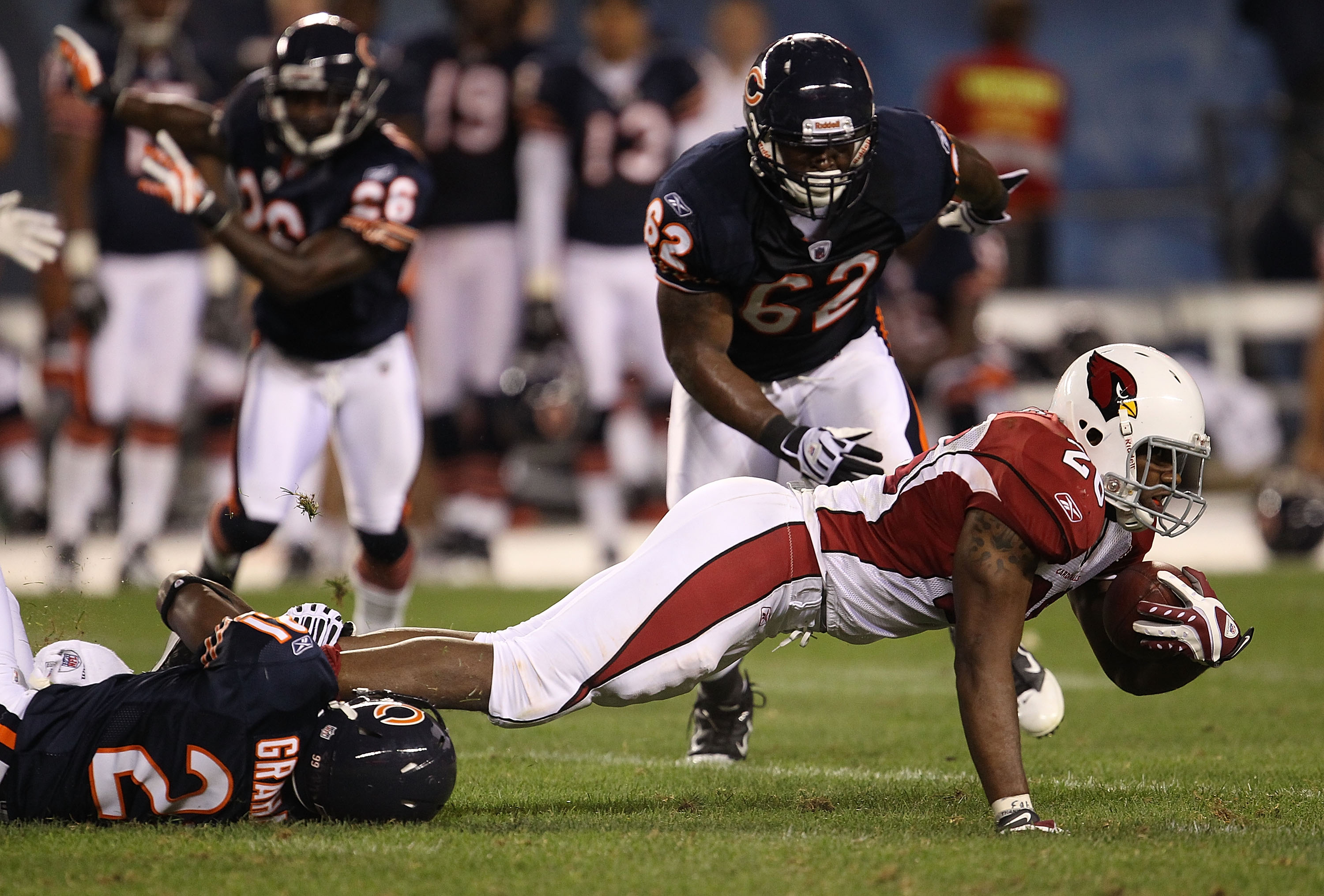 CHICAGO - AUGUST 28: Corey Graham #21 of the Chicago Bears drops Beanie Wells #26 of the Arizona Cardinals during a preseason game at Soldier Field on August 28, 2010 in Chicago, Illinois. The Cardinals defeated the Bears 14-9. (Photo by Jonathan Daniel/G