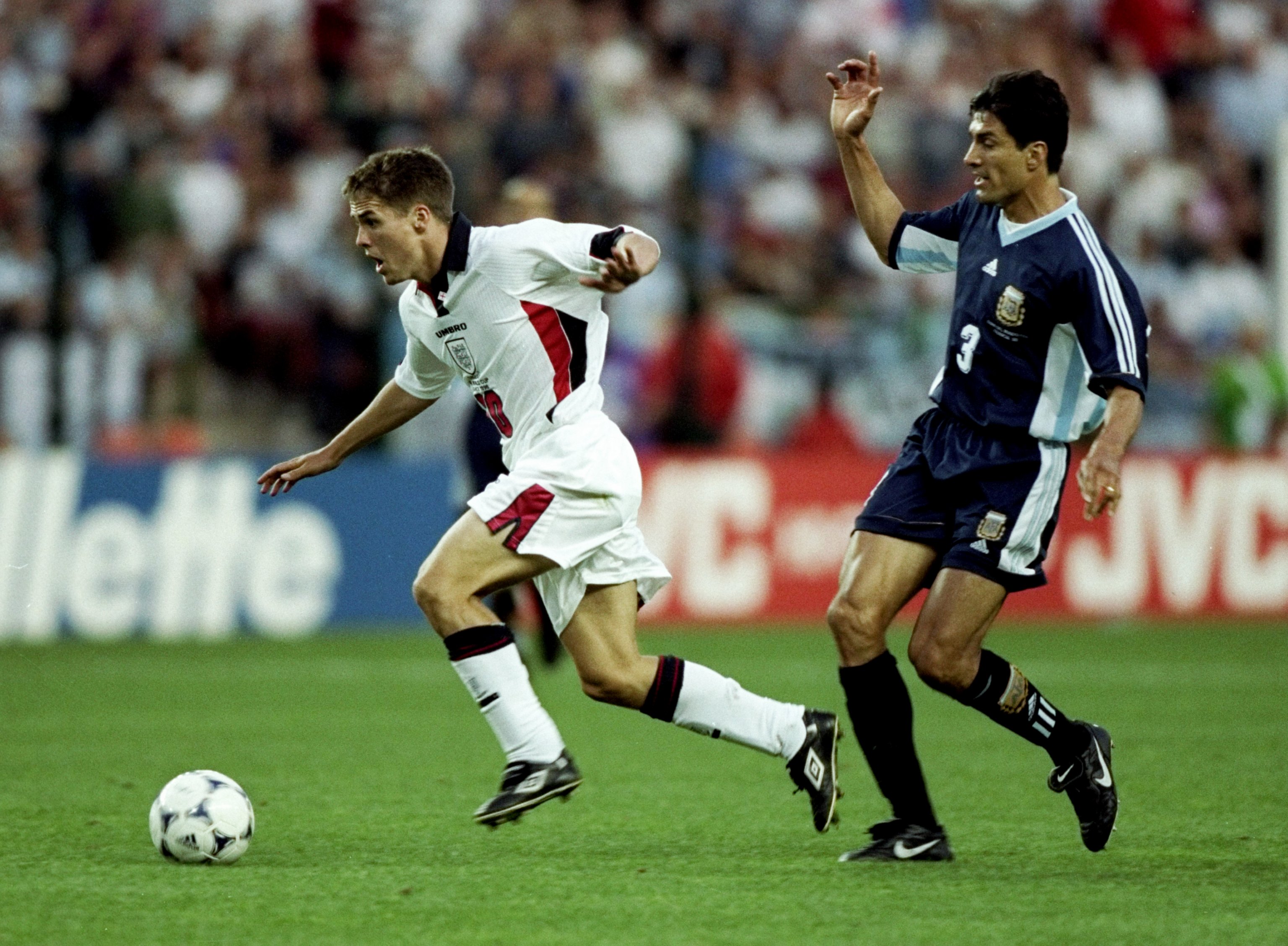 30 Jun 1998:  Michael Owen of England shrugs off Jose Chamot of Argentina on his way to goal during the World Cup second round match at the Stade Geoffroy Guichard in St Etienne, France. England lost 4-3 on penalties after a 2-2 draw. \ Mandatory Credit:R