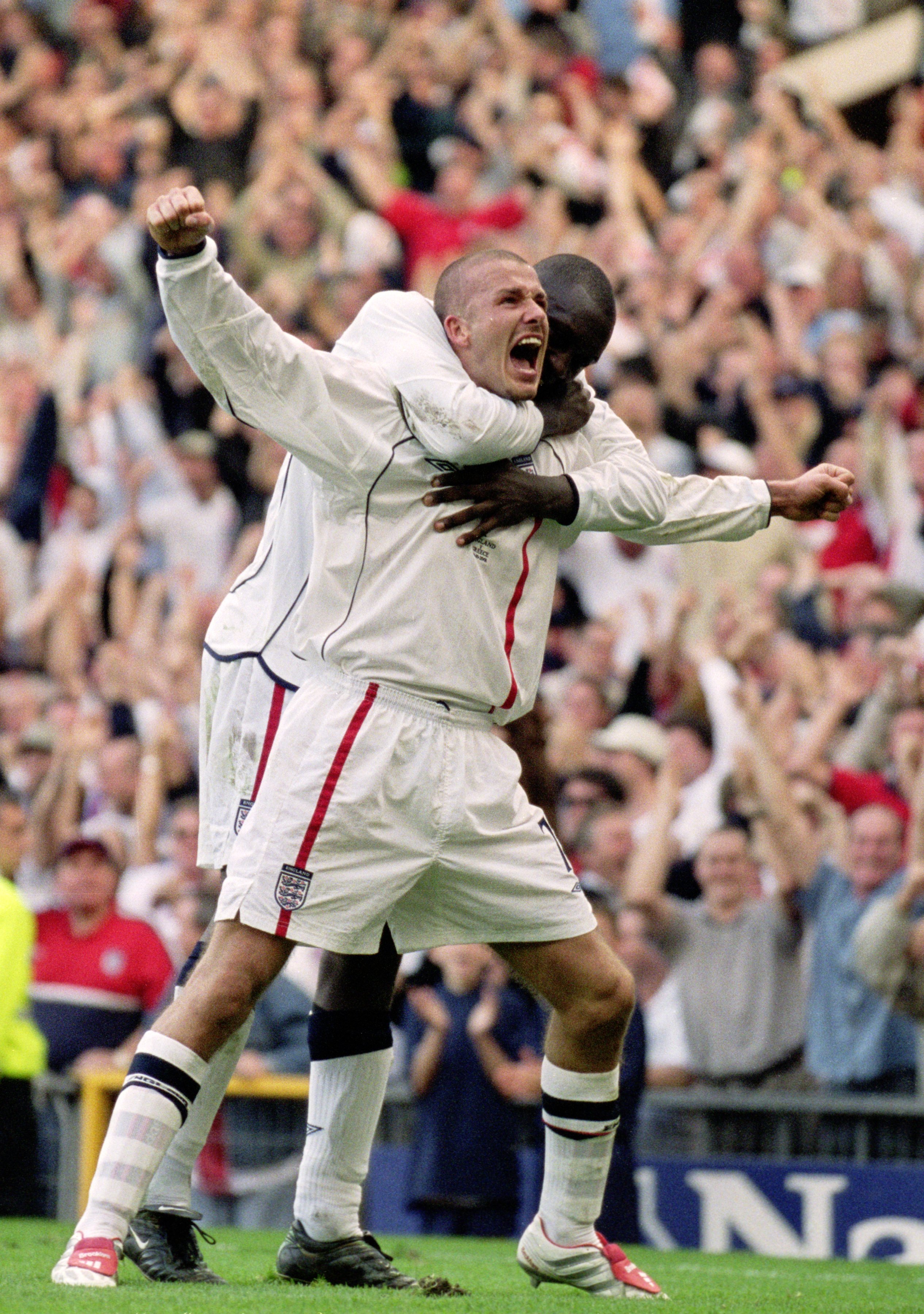 6 Oct 2001:  David Beckham of England celebrates with Emile Heskey after scoring an injury time equalising goal during the World Cup Group 9 Qualifier between England and Greece at Old Trafford in Manchester, England. England sealed qualification after th