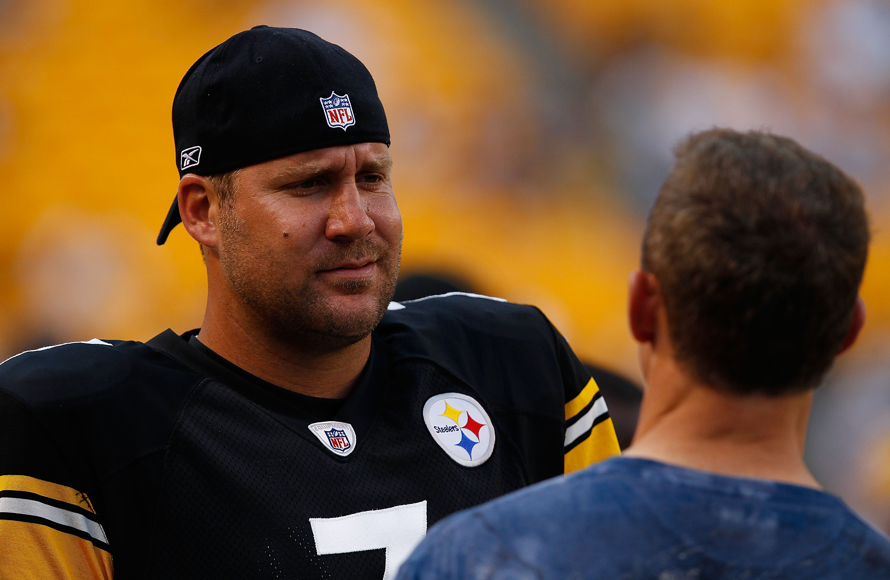 PITTSBURGH - AUGUST 14:  Ben Roethlisberger #7 of the Pittsburgh Steelers jokes around prior to the game with former Steeler Merril Hoge against the Detroit Lions on August 14, 2010 at Heinz Field in Pittsburgh, Pennsylvania. Steelers won 23-7.  (Photo by
