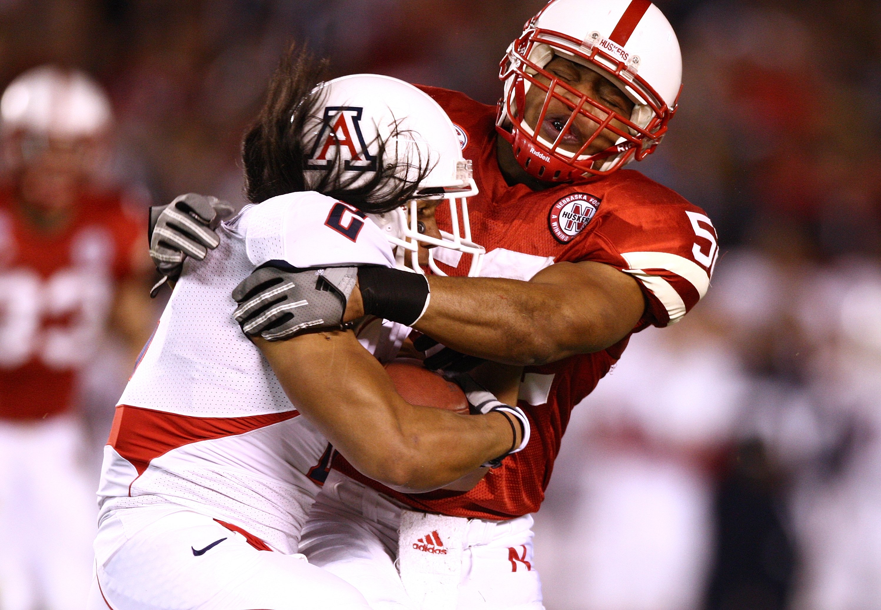 SAN DIEGO - DECEMBER 30: Phillip Dillard #52 of the University of Nebraska Cornhuskers tackles Keola Antolin #4 of the University of Arizona Wildcats during the Pacific Life Holiday Bowl on December 30, 2009 at Qualcomm Stadium in San Diego, California.