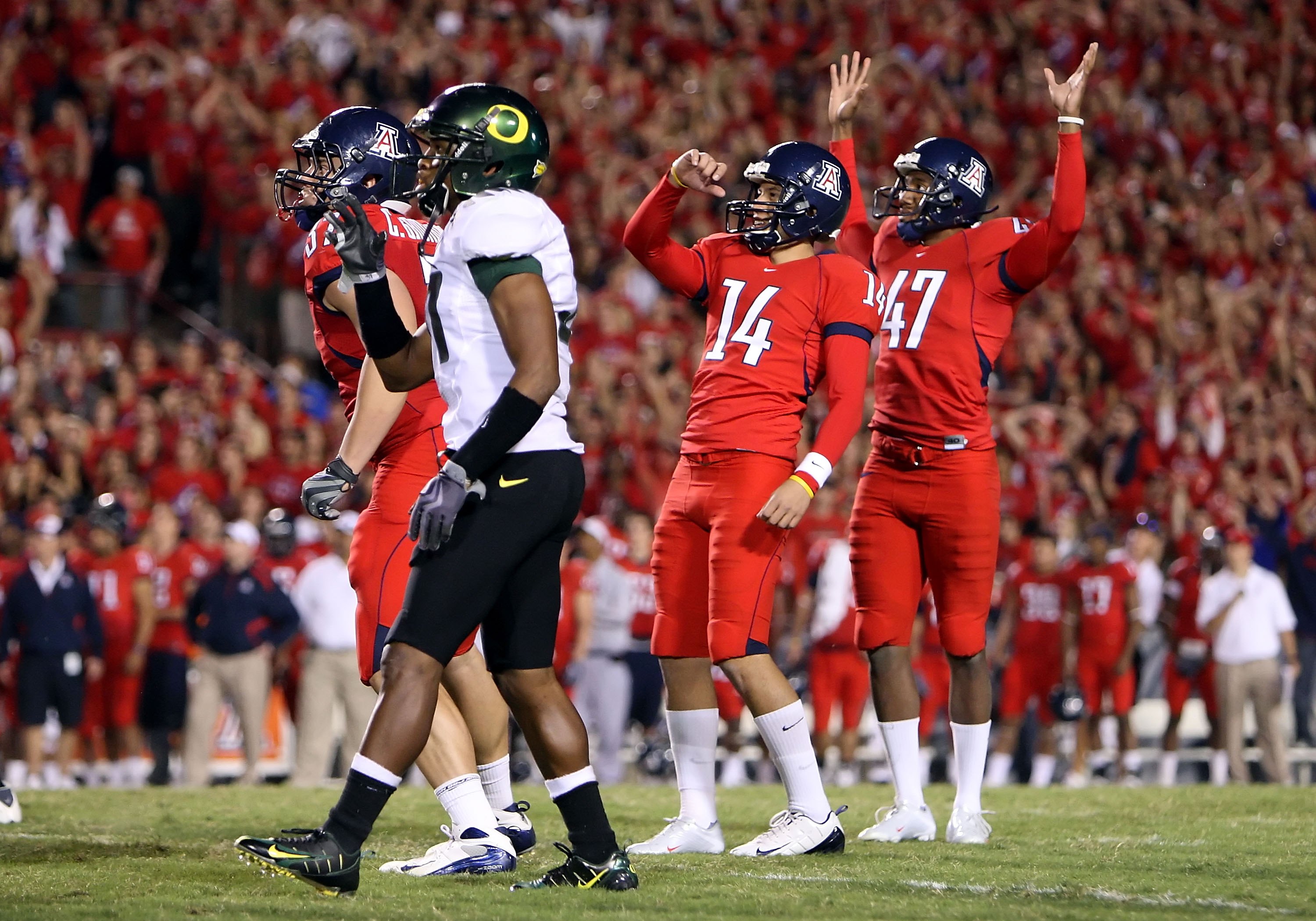 TUCSON, AZ - NOVEMBER 21: Kicker Alex Zendejas #14 and Keenyn Crier #47 of the Arizona Wildcats celebrate kicking a field goal against the Oregon Ducks during the college football game at Arizona Stadium on November 21, 2009 in Tucson, Arizona.The Ducks