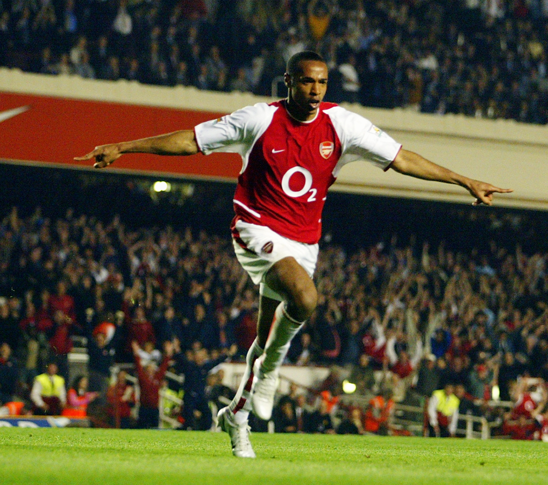LONDON - APRIL 16:   Thierry Henry of Arsenal celebrates scoring Arsenal's second goal during the FA Barclaycard Premiership match between Arsenal and Manchester United held on April 16, 2003 at Highbury in London, England. The match ended in a 2-2 draw.