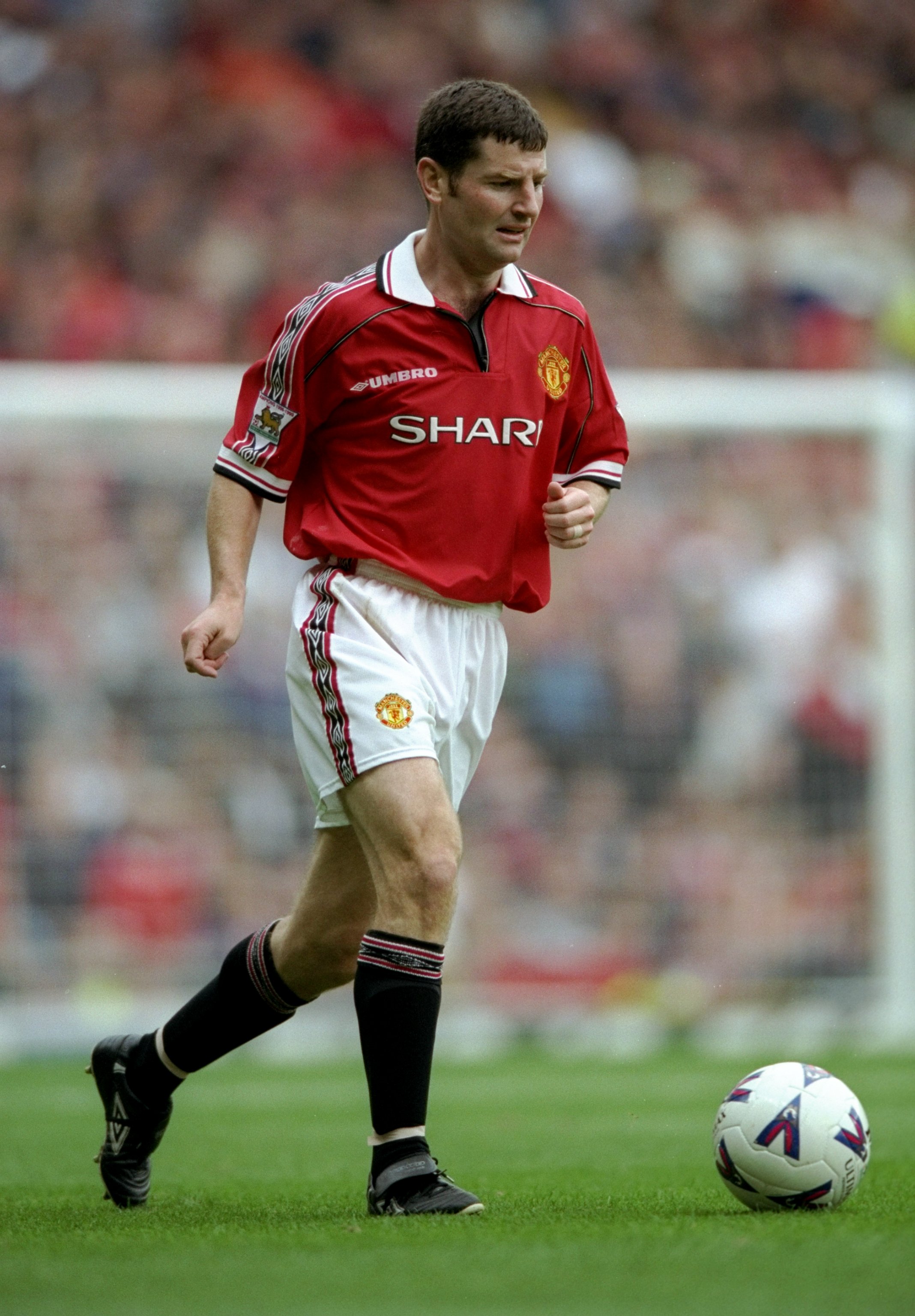 18 Sep 1999:  Denis Irwin of Manchester United in action during the FA Carling Premier League game between Manchester United and Wimbledon at Old Trafford, Manchester, England. The game finished in a 1-1 draw. \ Mandatory Credit: Shaun Botterill /Allsport