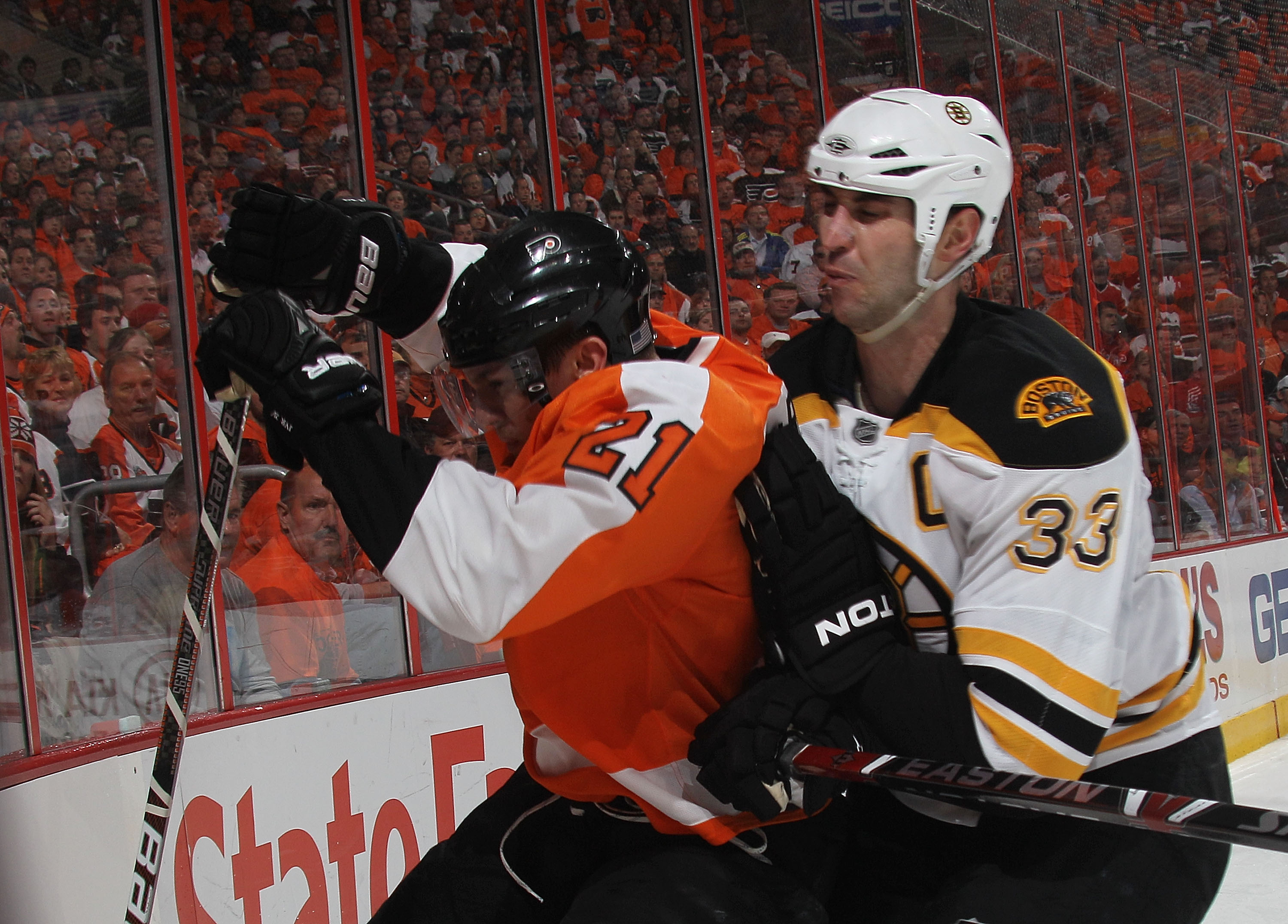 PHILADELPHIA - MAY 12:  Zdeno Chara #33 of the Boston Bruins rides James van Riemsdyk #21 of the Philadelphia Flyers into the boards in Game Six of the Eastern Conference Semifinals during the 2010 NHL Stanley Cup Finals at the Wachovia Center on May 12, 