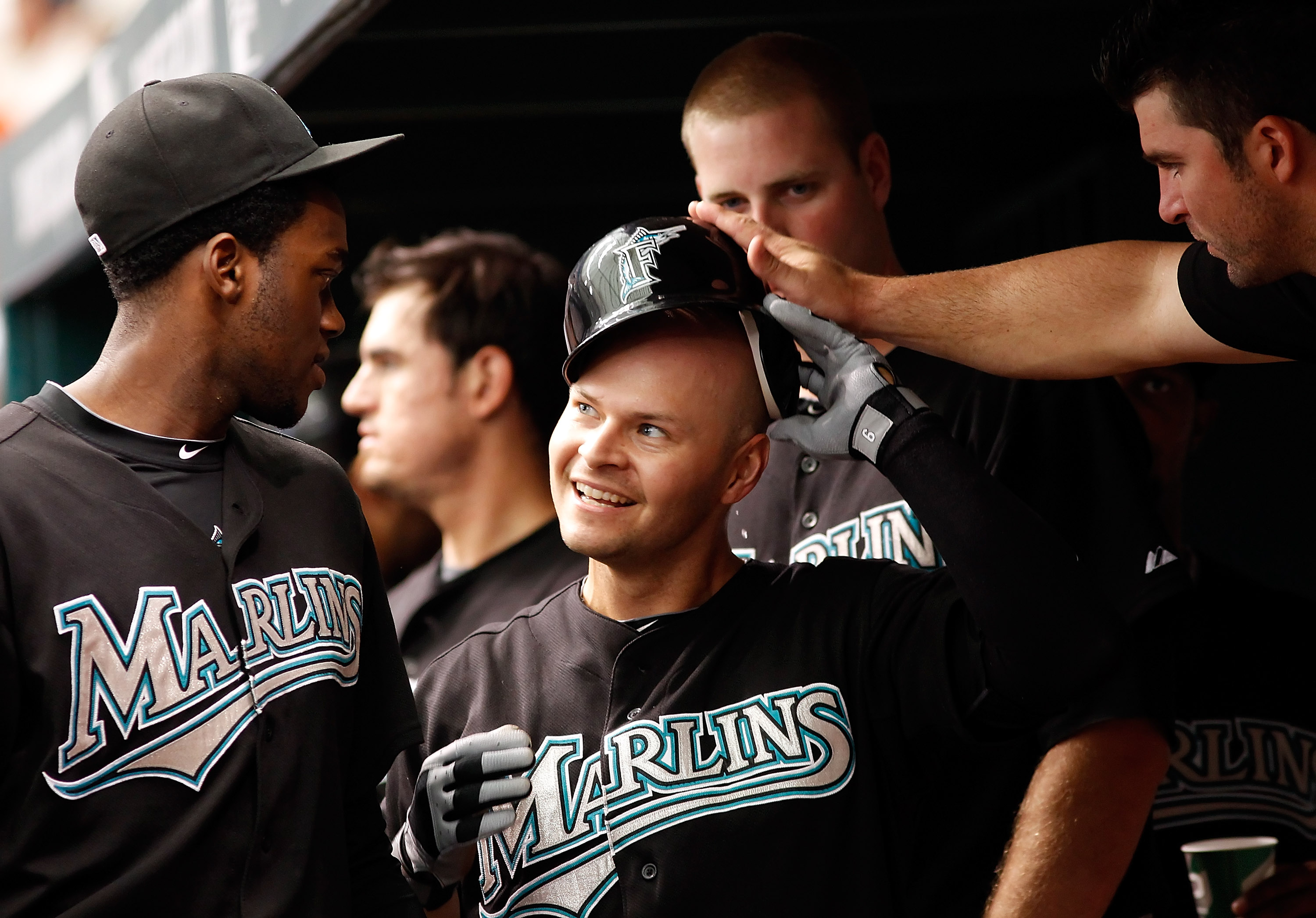 ST. PETERSBURG, FL - JUNE 13:  Outfielder Cody Ross #12 of the Florida Marlins is congratulated after scoring a run against the Tampa Bay Rays during the game at Tropicana Field on June 13, 2010 in St. Petersburg, Florida.  (Photo by J. Meric/Getty Images