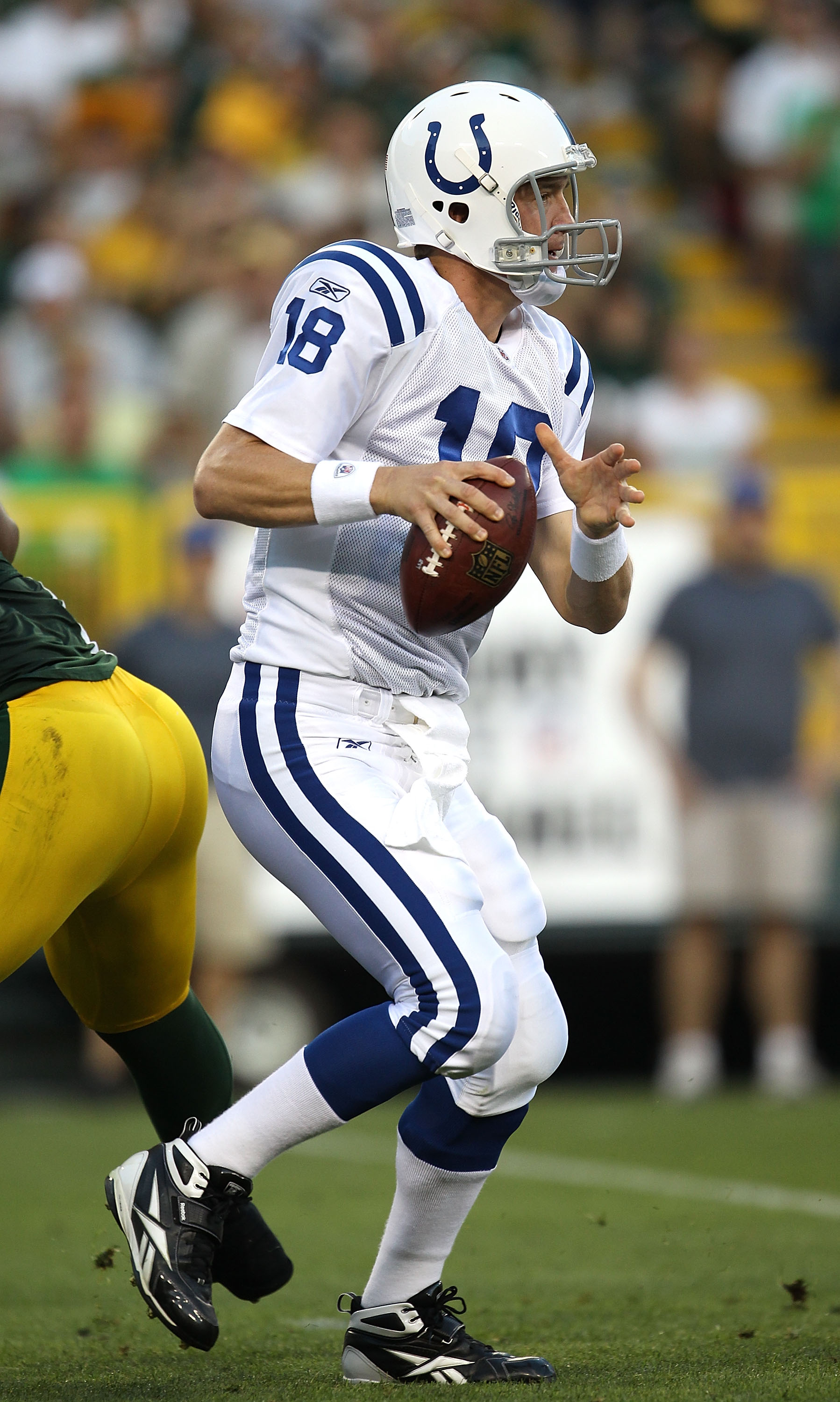 GREEN BAY, WI - AUGUST 26: Peyton Manning #18 of the Indianapolis Colts looks for a receiver against the Green Bay Packers during a preseason game at Lambeau Field on August 26, 2010 in Green Bay, Wisconsin. The Packers defeated the Colts 59-24.  (Photo b