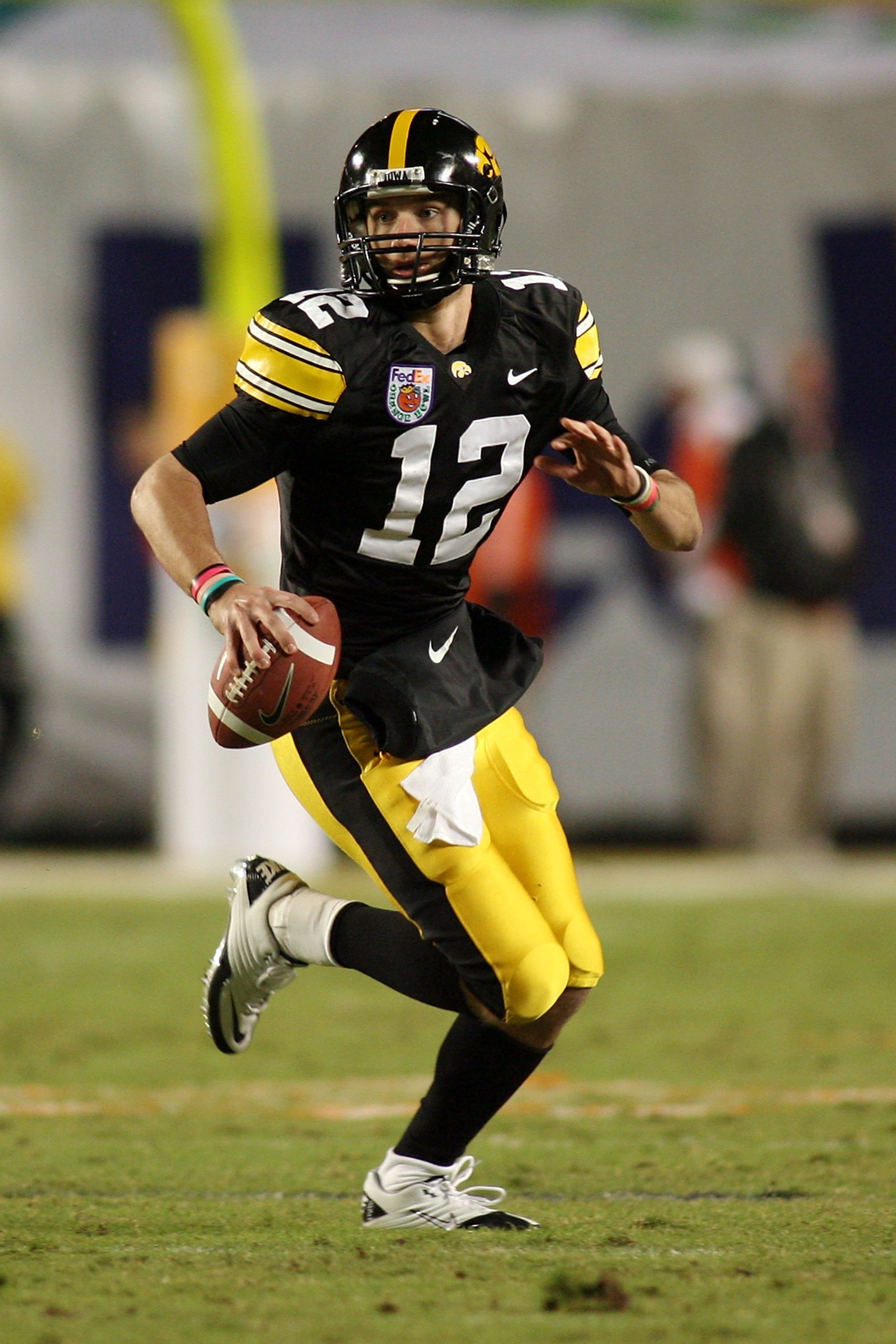 MIAMI GARDENS, FL - JANUARY 05: Quarterback Richy Stanzi #12 of the Iowa Hawkeyes rolls out of the pocket against the Georgia Tech Yellow Jackets during the FedEx Orange Bowl at Land Shark Stadium on January 5, 2010 in Miami Gardens, Florida. Iowa won 24