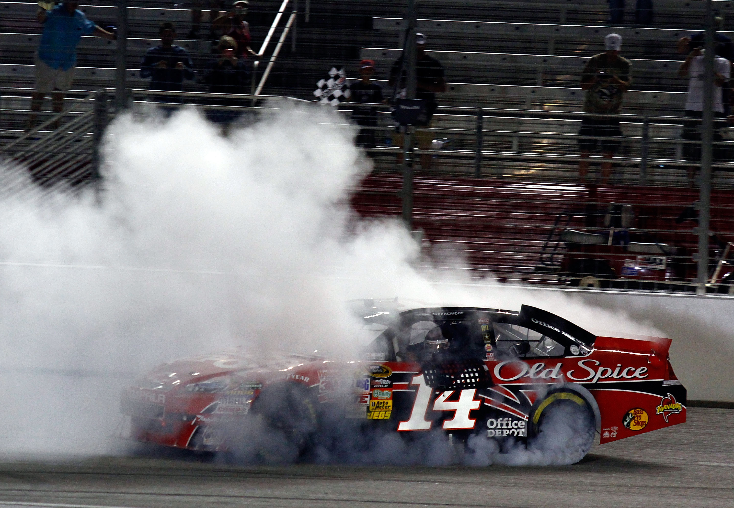 HAMPTON, GA - SEPTEMBER 05:  Tony Stewart, driver of the #14 Office Depot/Old Spice Chevrolet, performs a burnout to celebrate after winning the NASCAR Sprint Cup Series Emory Healthcare 500 at Atlanta Motor Speedway on September 5, 2010 in Hampton, Georg