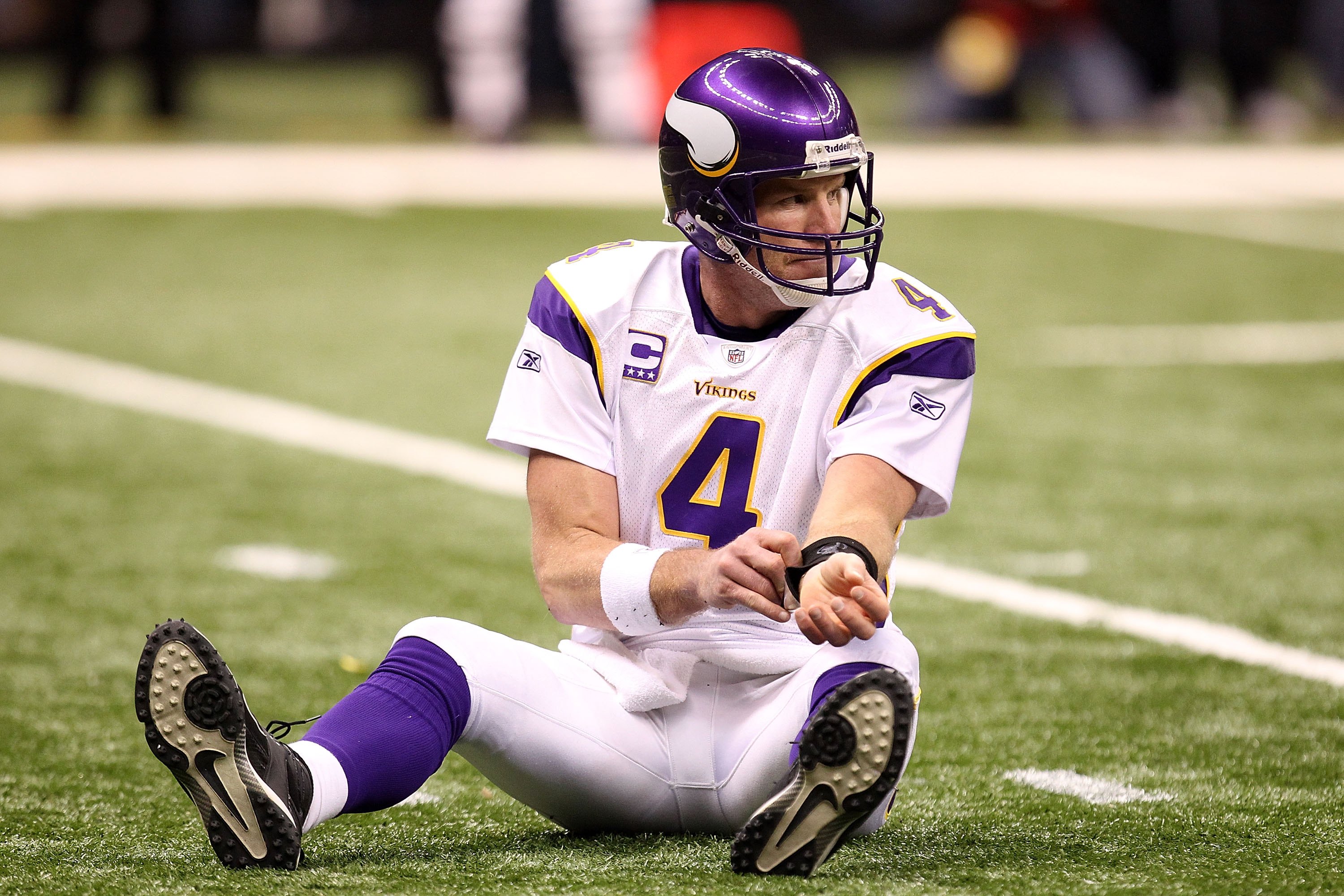 NEW ORLEANS - JANUARY 24:  Brett Favre #4 of the Minnesota Vikings sits on the turf after getting knocked down on a play against the New Orleans Saints during the NFC Championship Game at the Louisana Superdome on January 24, 2010 in New Orleans, Louisian