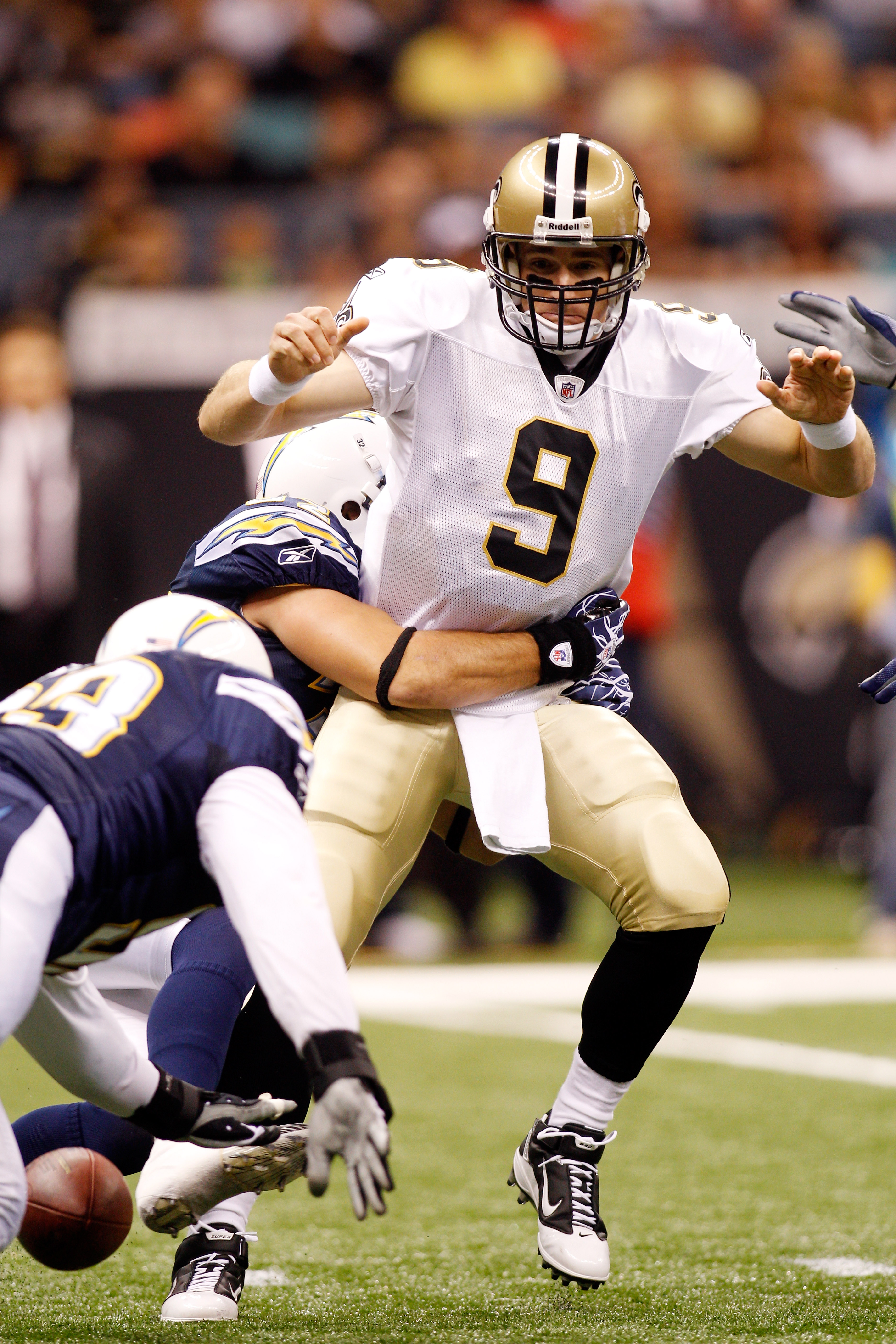 NEW ORLEANS - AUGUST 27:  Eric Weddle #32 of the San Diego Chargers strips the ball from Drew Brees #9 of the New Orleans Saints at the Louisiana Superdome on August 27, 2010 in New Orleans, Louisiana.  (Photo by Chris Graythen/Getty Images)
