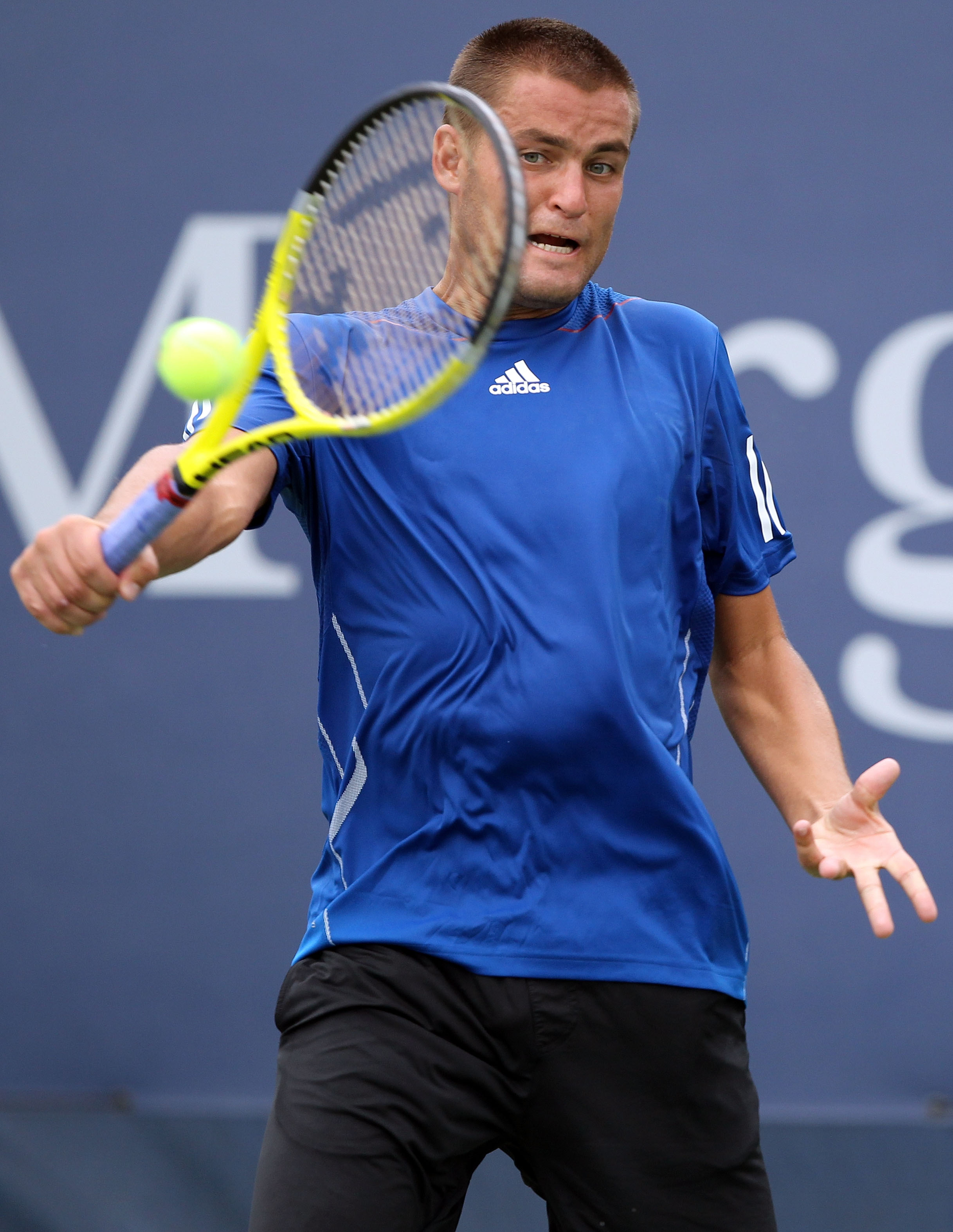 NEW YORK - SEPTEMBER 03:  Mikhail Youzhny of Russia returns a shot against Dudi Sela of Israel during his men's singles match on day five of the 2010 U.S. Open at the USTA Billie Jean King National Tennis Center on September 3, 2010 in the Flushing neighb