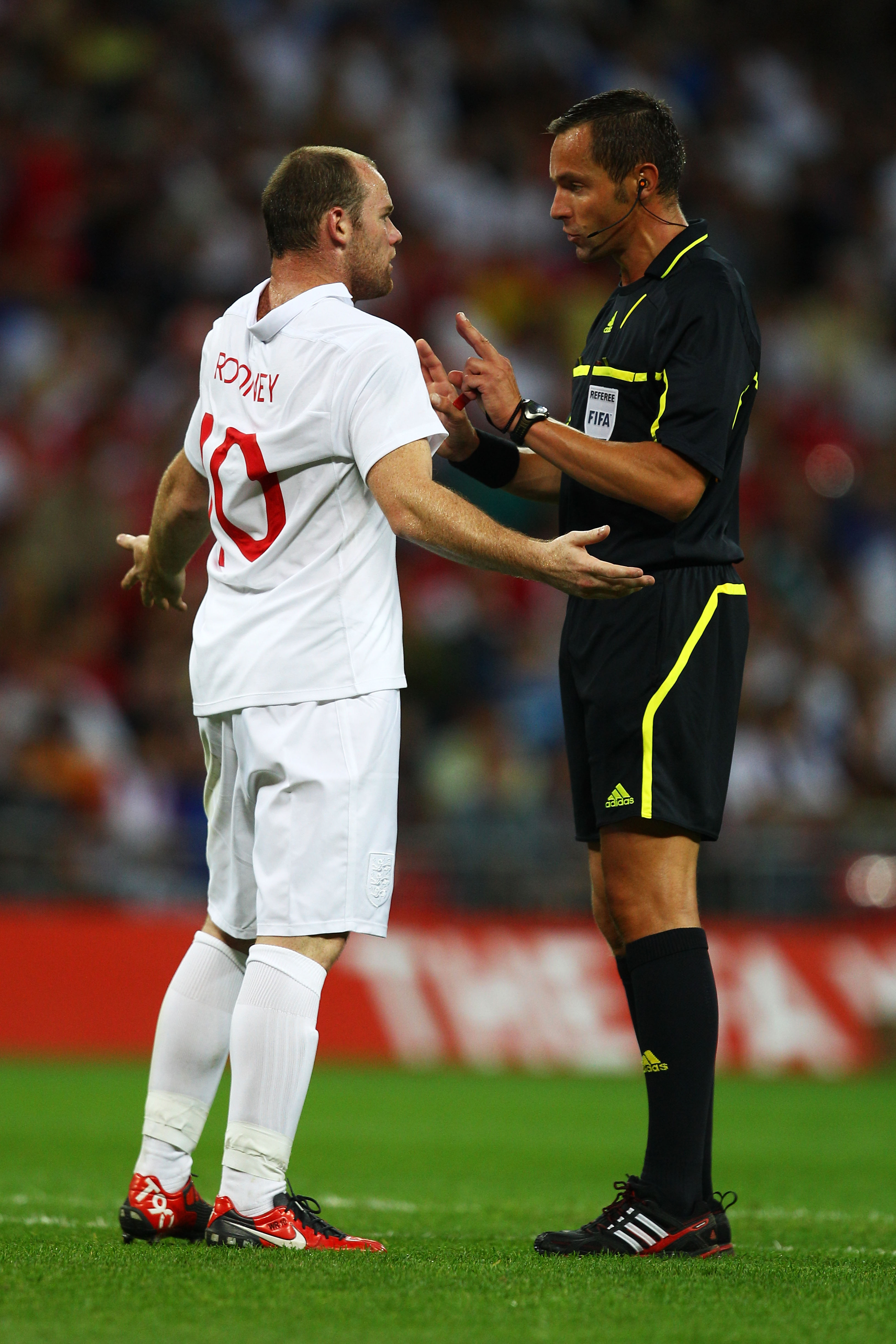 LONDON, ENGLAND - AUGUST 11:  Wayne Rooney of England reacts as he is spoken to by Referee Stephane Lannoy of France during the International Friendly match between England and Hungary at Wembley Stadium on August 11, 2010 in London, England.  (Photo by R