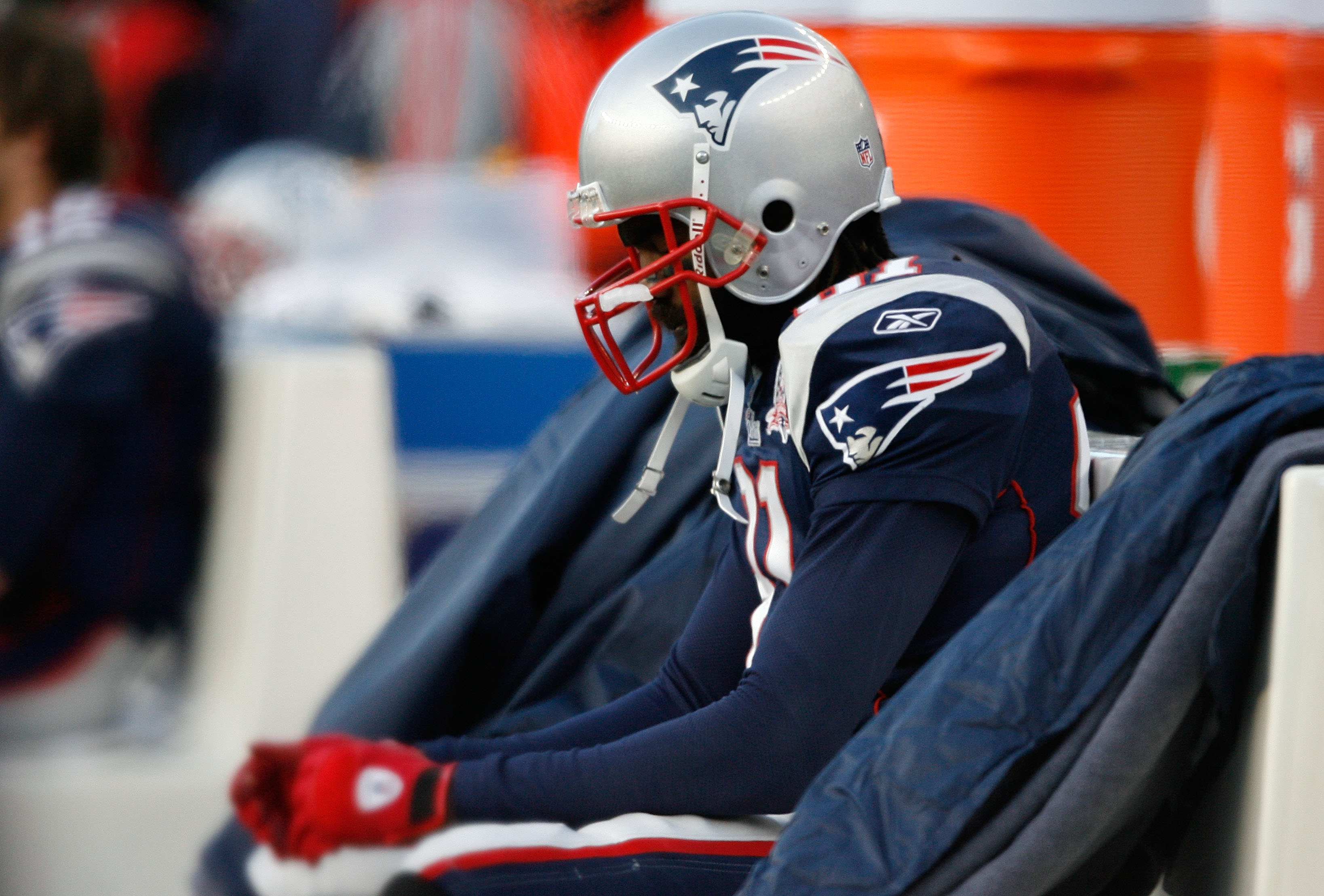 Randy Moss of the New England Patriots adjust his pink gloves