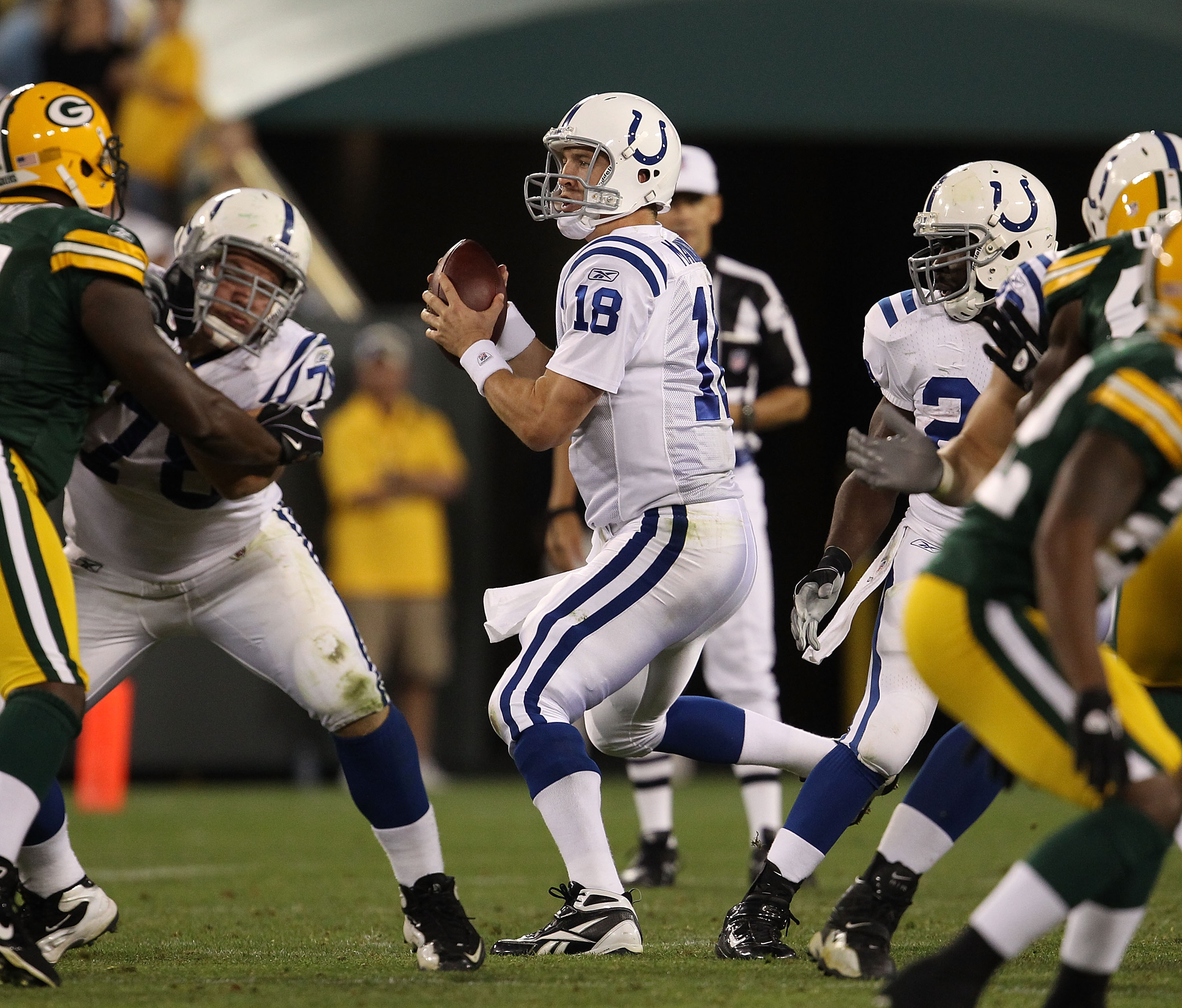 GREEN BAY, WI - AUGUST 26: Peyton Manning #18 of the Indianapolis Colts drops back to pass against the Green Bay Packers during a preseason game at Lambeau Field on August 26, 2010 in Green Bay, Wisconsin.  The Packers defeated the Colts 59-24.  (Photo by
