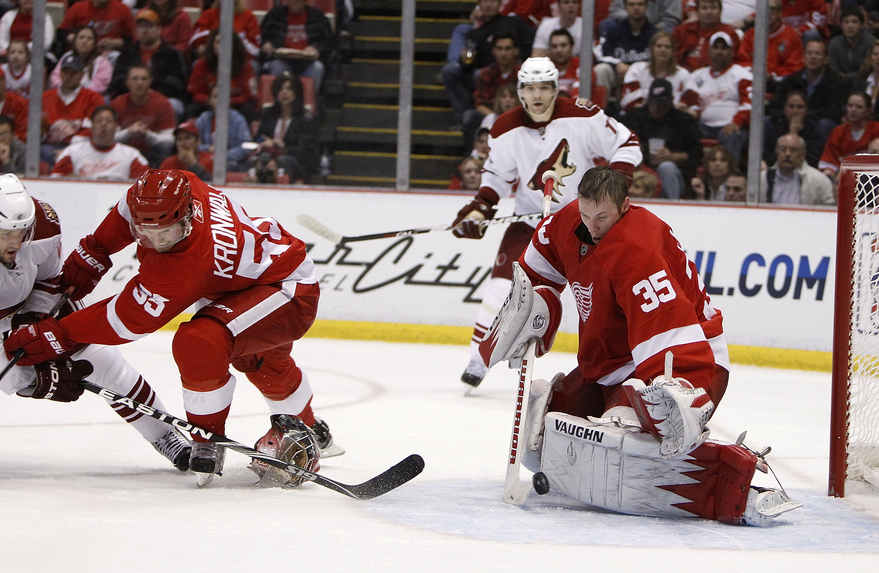 DETROIT - APRIL 20:  Jimmy Howard #35 of the Detroit Red Wings makes a save without his goalie mask behind teammate Niklas Kronwall #55 and Lee Stempniak #22 of the Phoenix Coyotes during Game Four of the Western Conference Quarterfinals of the 2010 NHL S