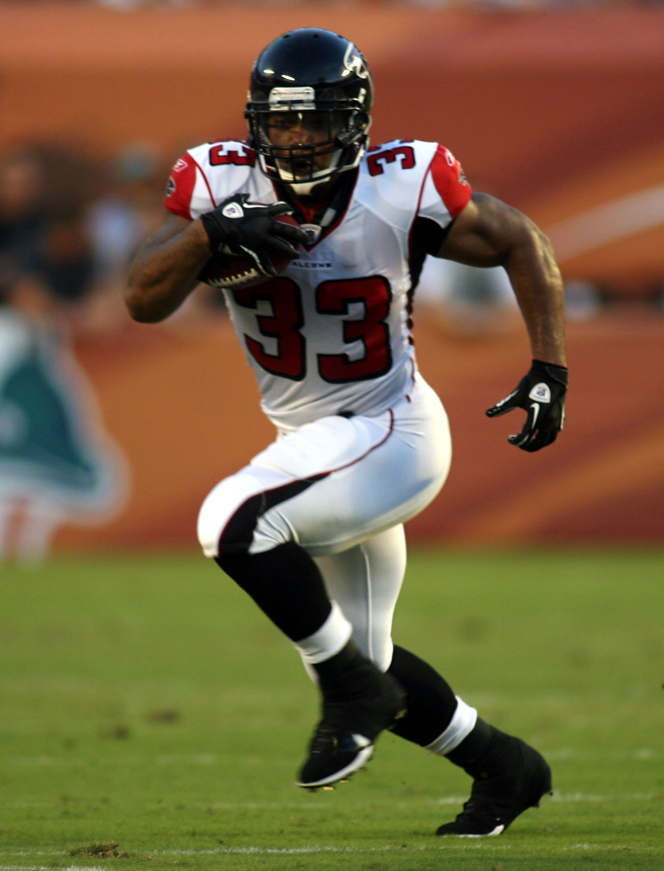 Atlanta Falcons running back Michael Turner (33) runs past San Diego  Chargers Steve Gregory (28) during their NFL pre-season game against the  San Diego Chargers at the Georgia Dome in Atlanta Saturday