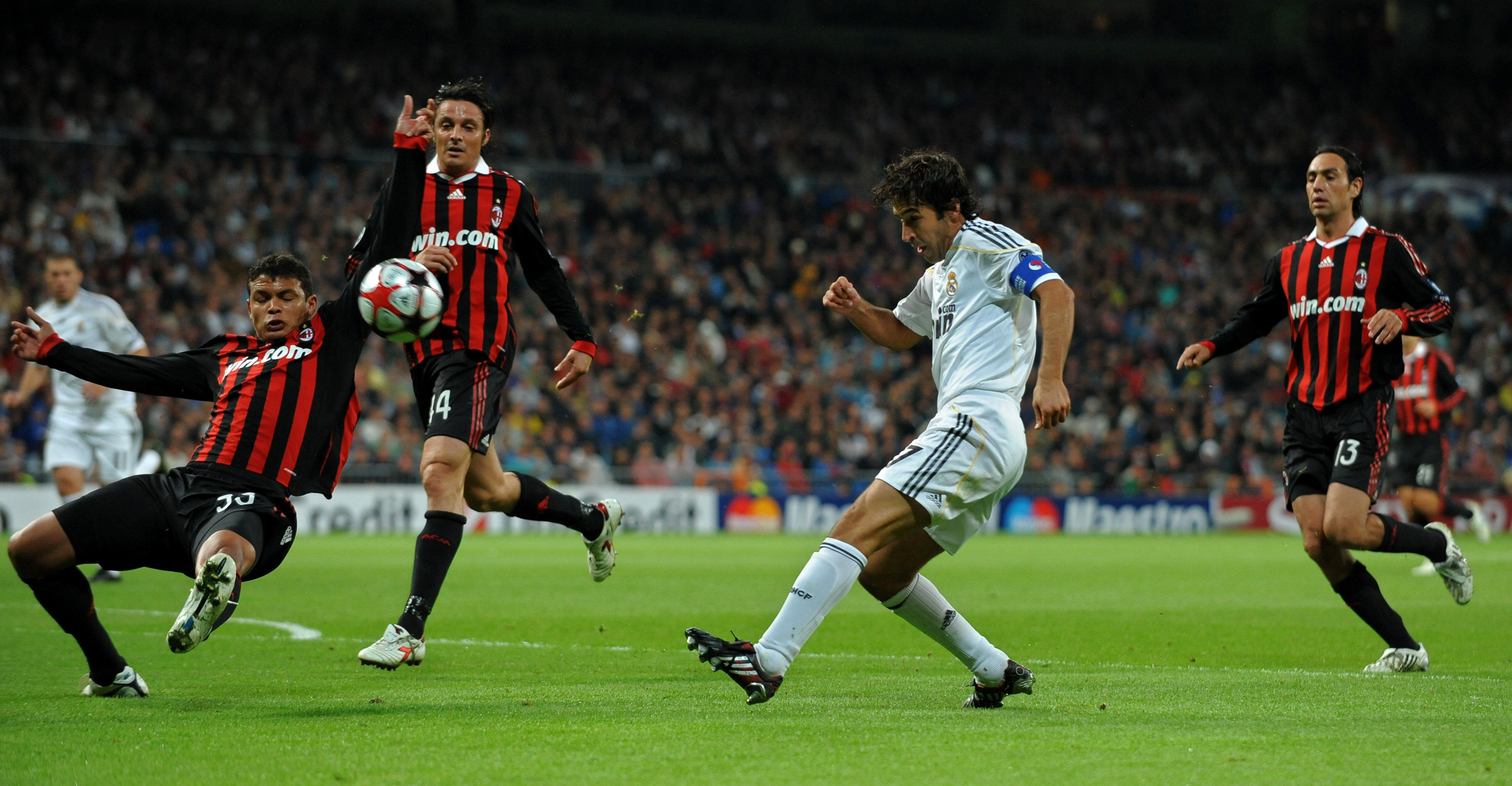 MADRID, SPAIN - OCTOBER 21:  Raul Gonzalez (2nd R) of Real Madrid shoots on goal in between AC Milan players Alessandro Nesta (R), Thiago Silva (L) and Massimo Oddo during the Champions League group C match between Real Madrid and AC Milan at the Estadio