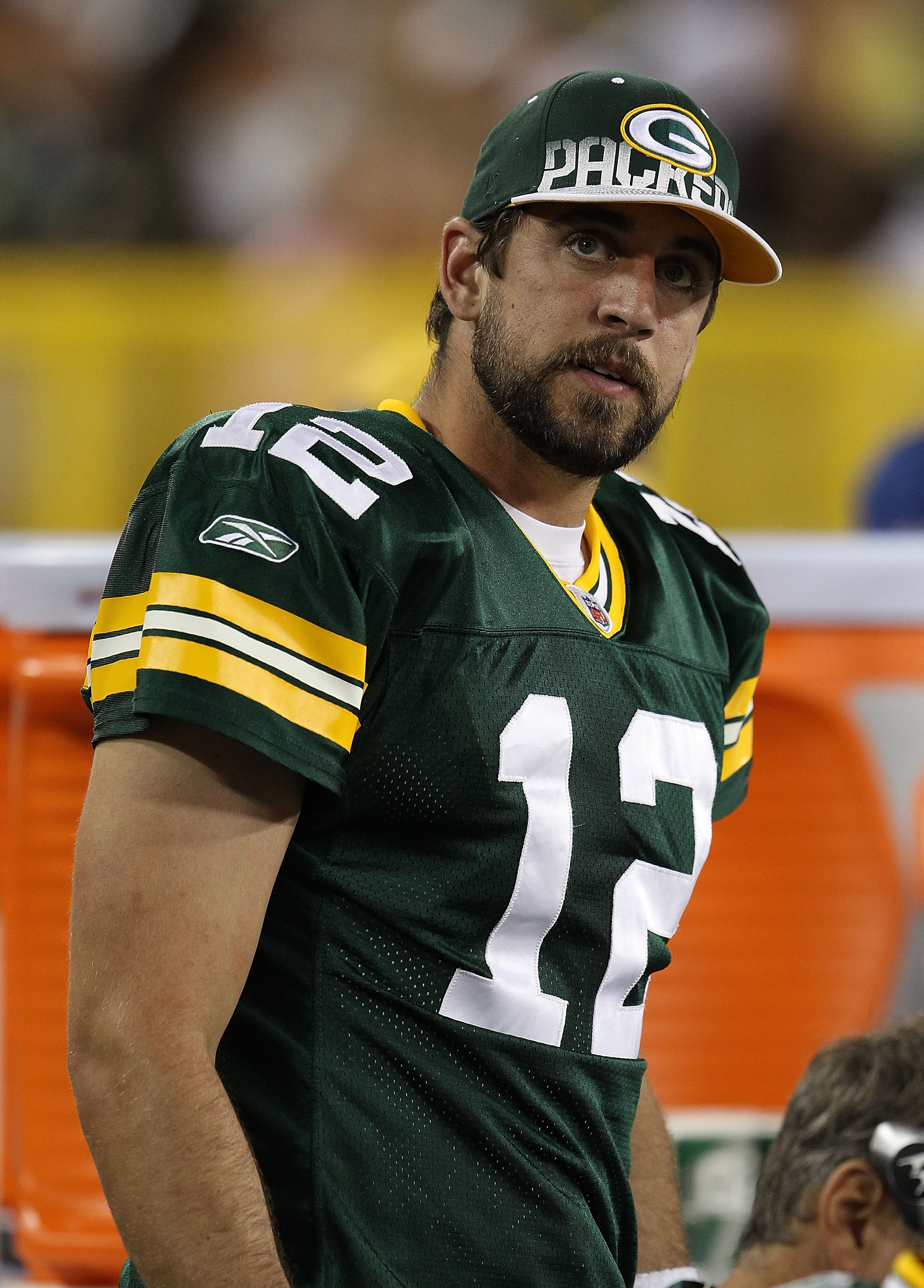 GREEN BAY, WI - AUGUST 26: Aaron Rodgers #12 of the Green Bay Packers watches as his teammates take on the Indianapolis Colts during a preseason game at Lambeau Field on August 26, 2010 in Green Bay, Wisconsin. The Packers defeated the Colts 59-24. (Photo