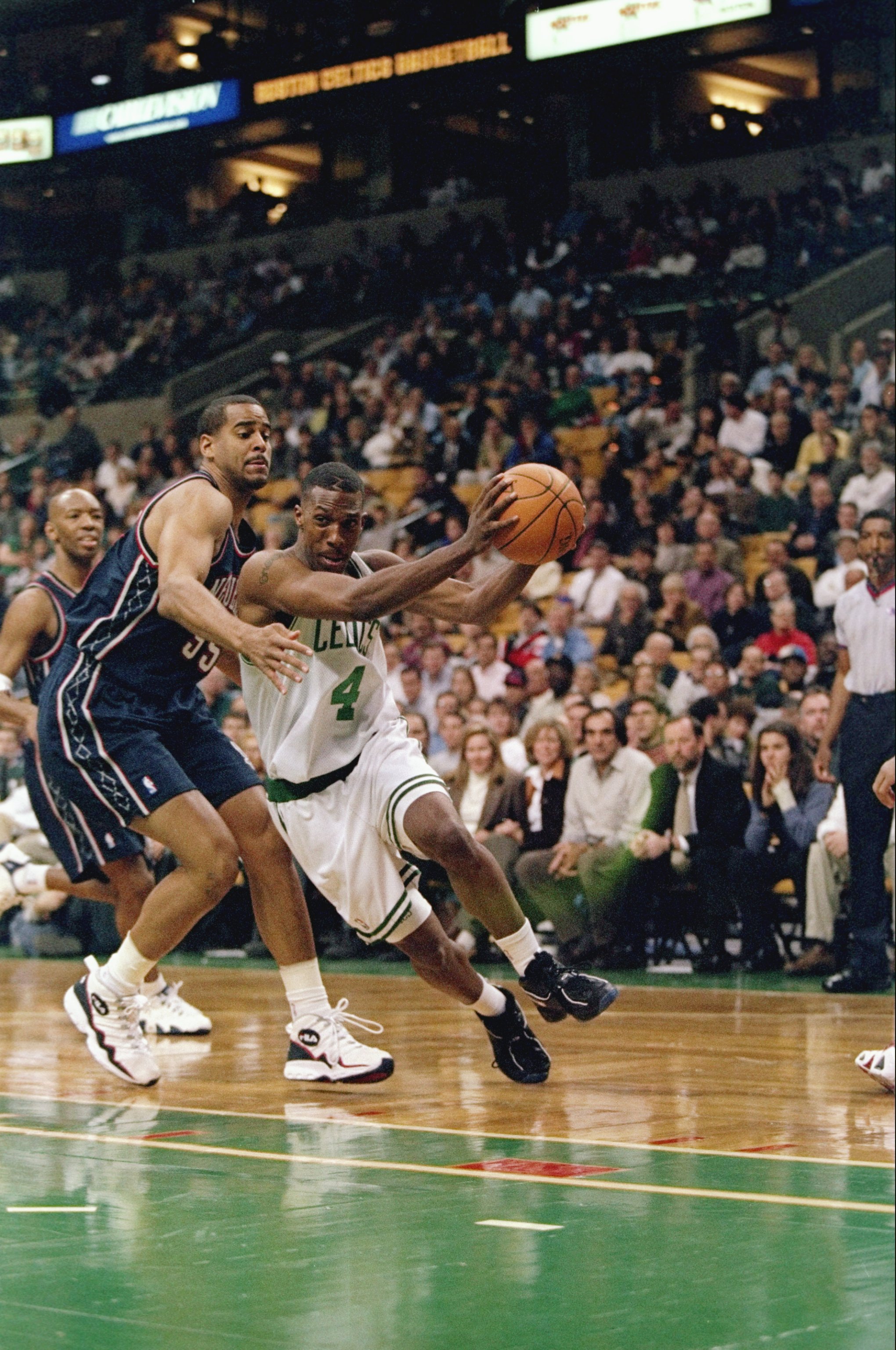 21 Nov 1997:  Guard Chauncey Billups of the Boston Celtics (right) in action against forward Jayson Williams of the New Jersey Nets during a game at the Fleet Center in Boston, Massachusetts.  The Celtics won the game 101-93. Mandatory Credit: Jamie Squir