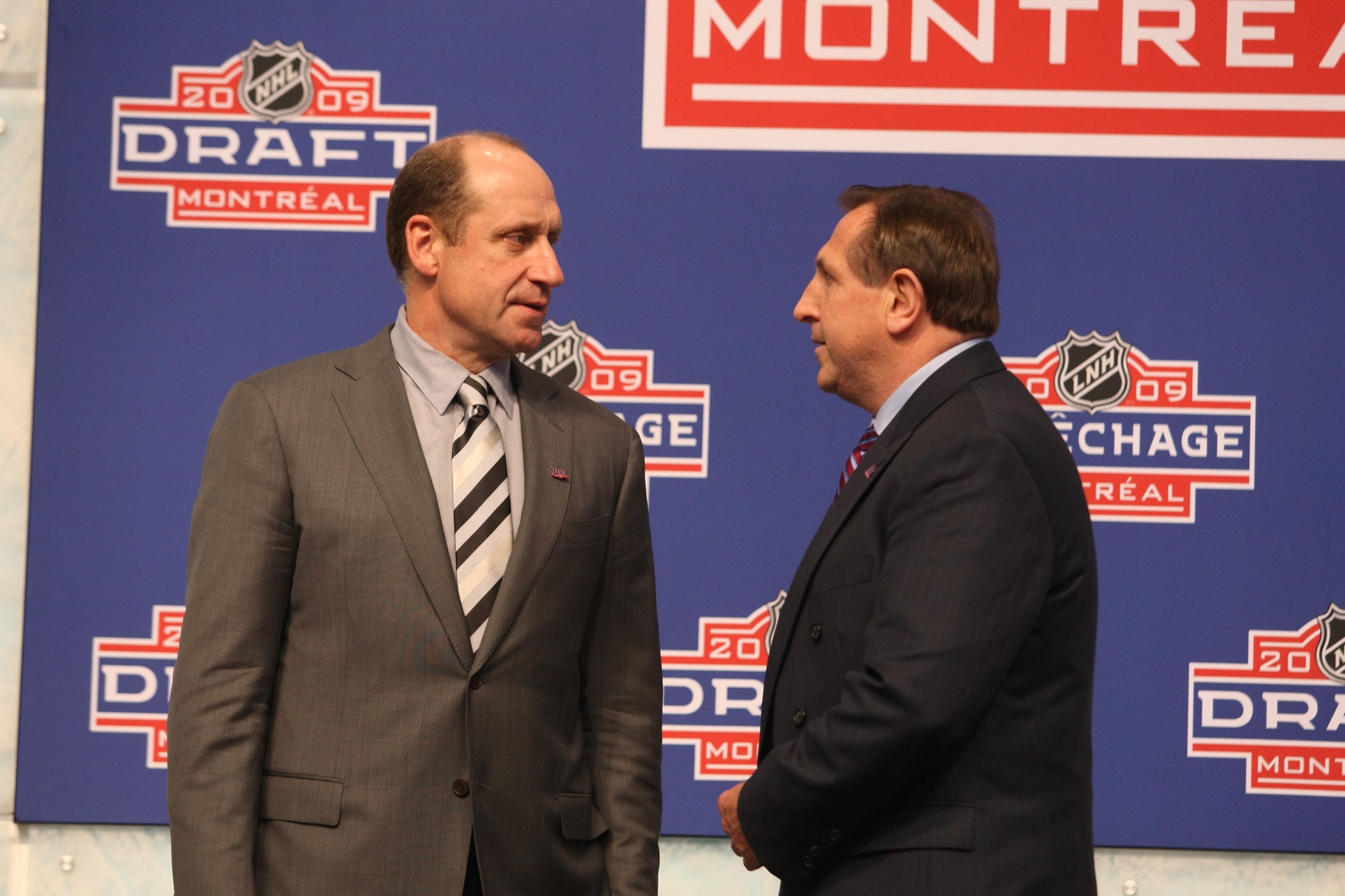 MONTREAL - JUNE 26:  Executive Vice President and General Manager Bob Gainey of the Montreal Canadiens speaks with head coach Jacques Martin during the first round of the 2009 NHL Entry Draft at the Bell Centre on June 26, 2009 in Montreal, Quebec, Canada