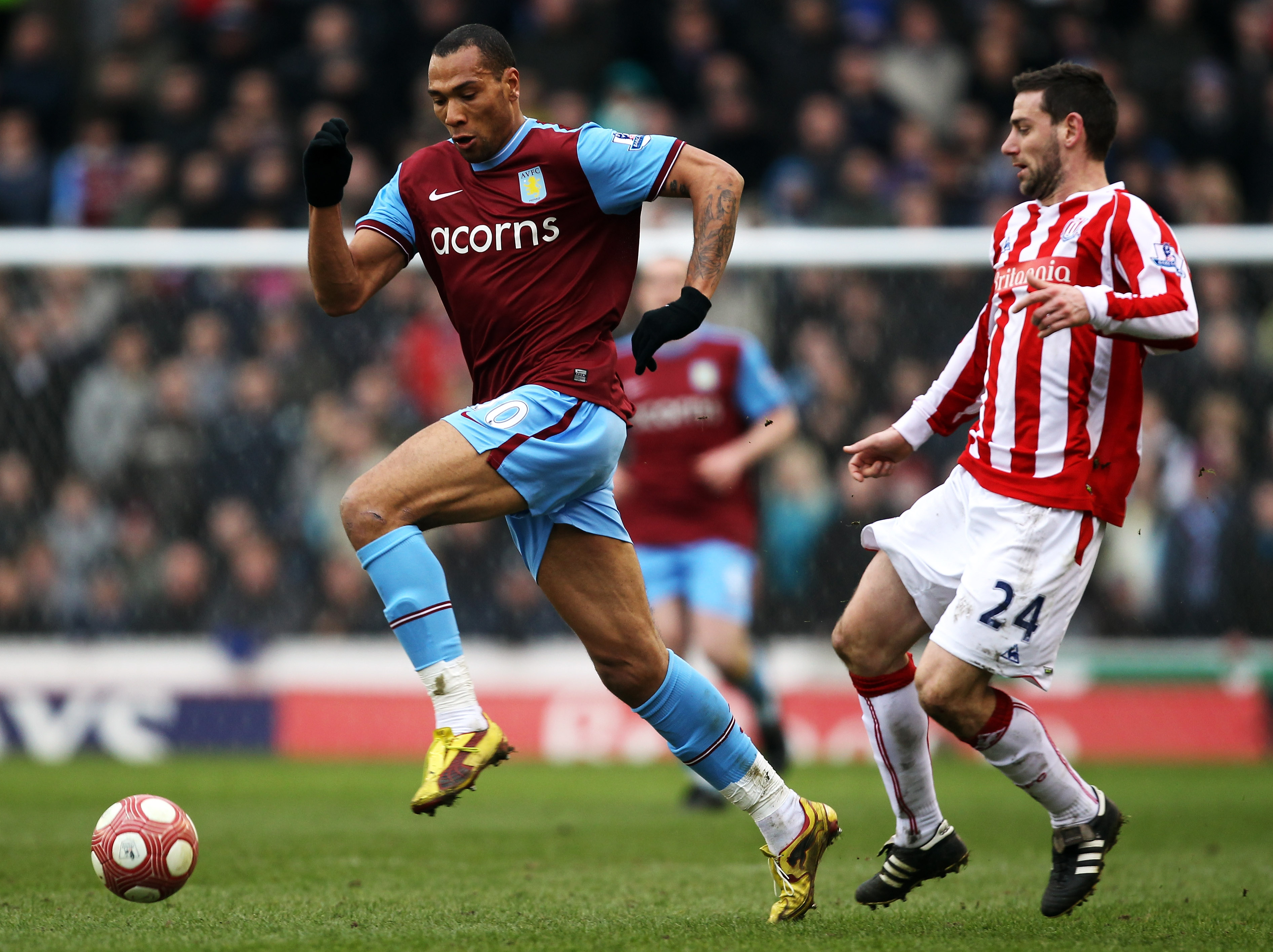 STOKE ON TRENT, ENGLAND - MARCH 13:  John Carew of Aston Villa avoids Rory Delap of Stoke City during the Barclays Premier League match between Stoke City and Aston Villa at Britannia Stadium on March 13th, 2010 in Stoke on Trent, England.  (Photo by Bryn