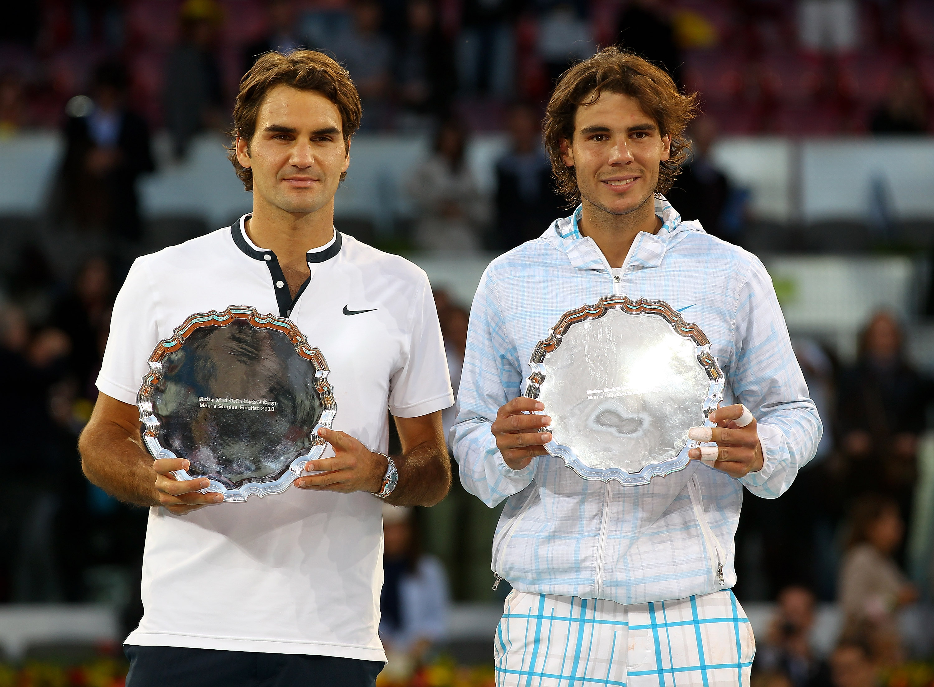 MADRID, SPAIN - MAY 16:  Mens finalist Rafael Nadal and  Roger Federer of Switzerland hold aloft their trophies after the mens final match during the Mutua Madrilena Madrid Open tennis tournament at the Caja Magica on May 16, 2010 in Madrid, Spain.  (Phot