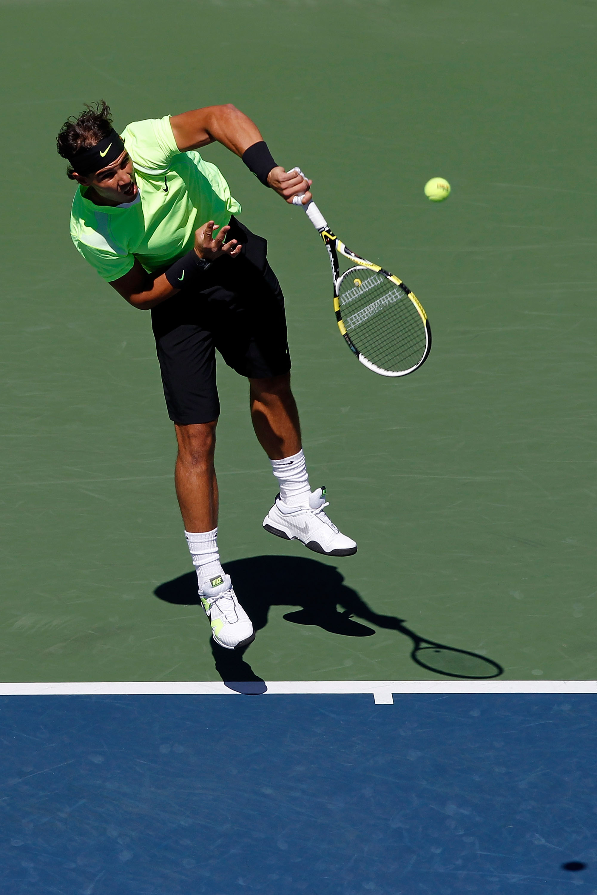 NEW YORK - SEPTEMBER 11:  Rafael Nadal of Spain serves against Mikhail Youzhny of Russia during his men's singles semifinal match on day thirteen of the 2010 U.S. Open at the USTA Billie Jean King National Tennis Center on September 11, 2010 in the Flushi