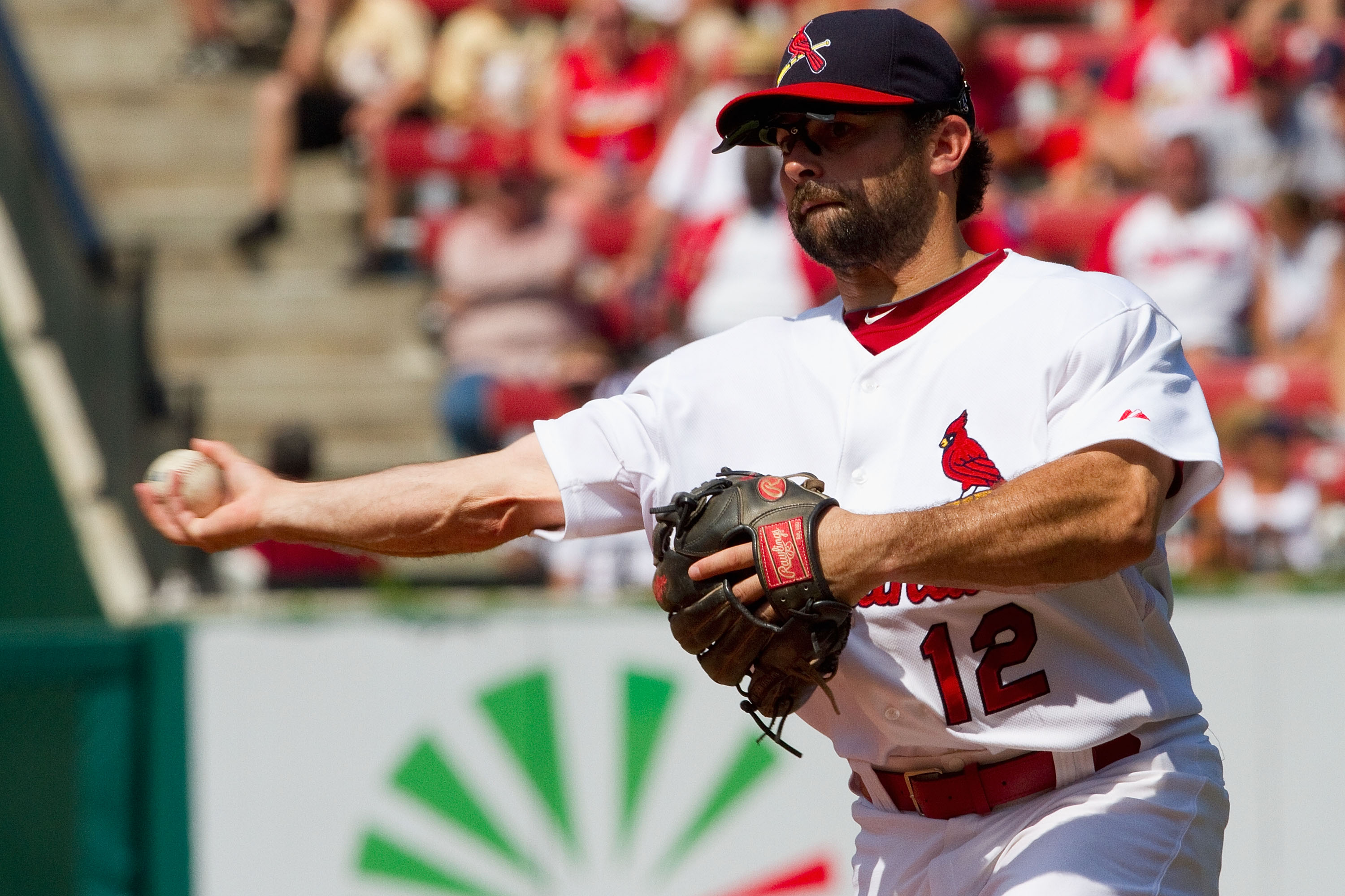 ST. LOUIS - AUGUST 1: Aaron Miles #12 of the St. Louis Cardinals throws to first base against the Pittsburgh Pirates at Busch Stadium on August 1, 2010 in St. Louis, Missouri.  The Cardinals beat the Pirates 9-1.  (Photo by Dilip Vishwanat/Getty Images)