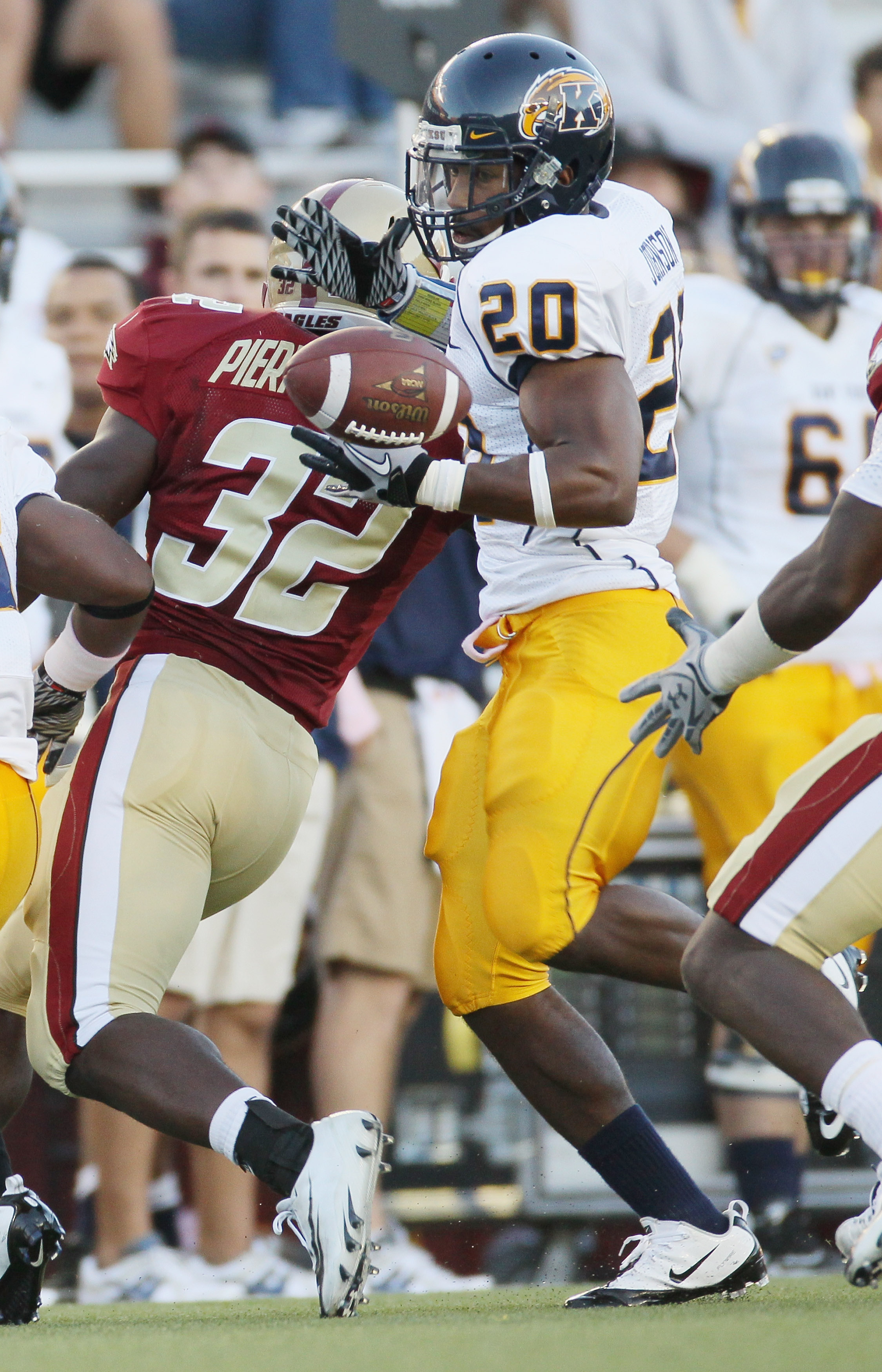 CHESTNUT HILL, MA - SEPTEMBER 11: Will Johnson #20 of the Kent State Golden Flashes cannot hang on to teammate Leneric Muldrow's fumble as Kevin Pierre-Lewis #32 of the Boston College Eagles defends on September 11, 2010 at Alumni Stadium in Chestnut Hil