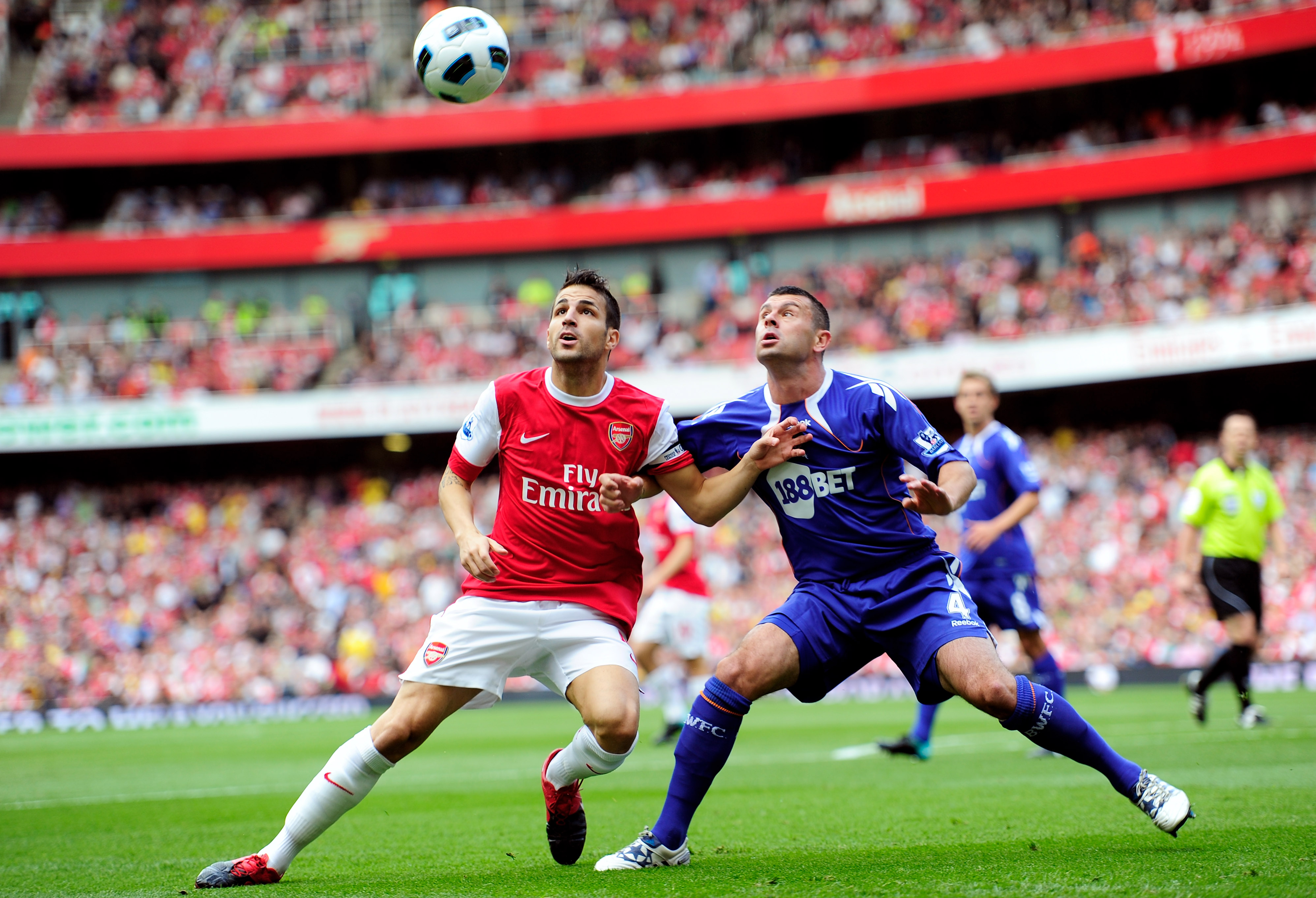 LONDON, ENGLAND - SEPTEMBER 11:  Cesc Fabregas of Arsenal battles with Paul Robinson of Bolton during the Barclays Premier League match between Arsenal and Bolton Wanderers at The Emirates Stadium on September 11, 2010 in London, England.  (Photo by Jamie