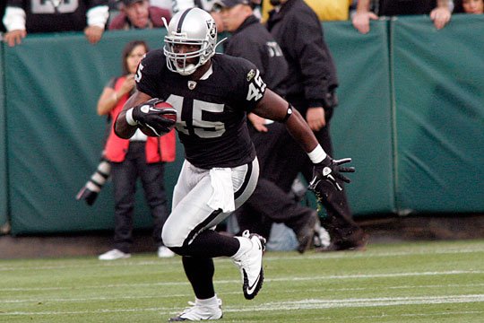 Oakland Raiders running backs Darren McFadden, left, and Rock Cartwright,  right, rest between drills during their NFL football training camp in Napa,  Calif., Thursday, July 28, 2011. (AP Photo/Eric Risberg Stock Photo 