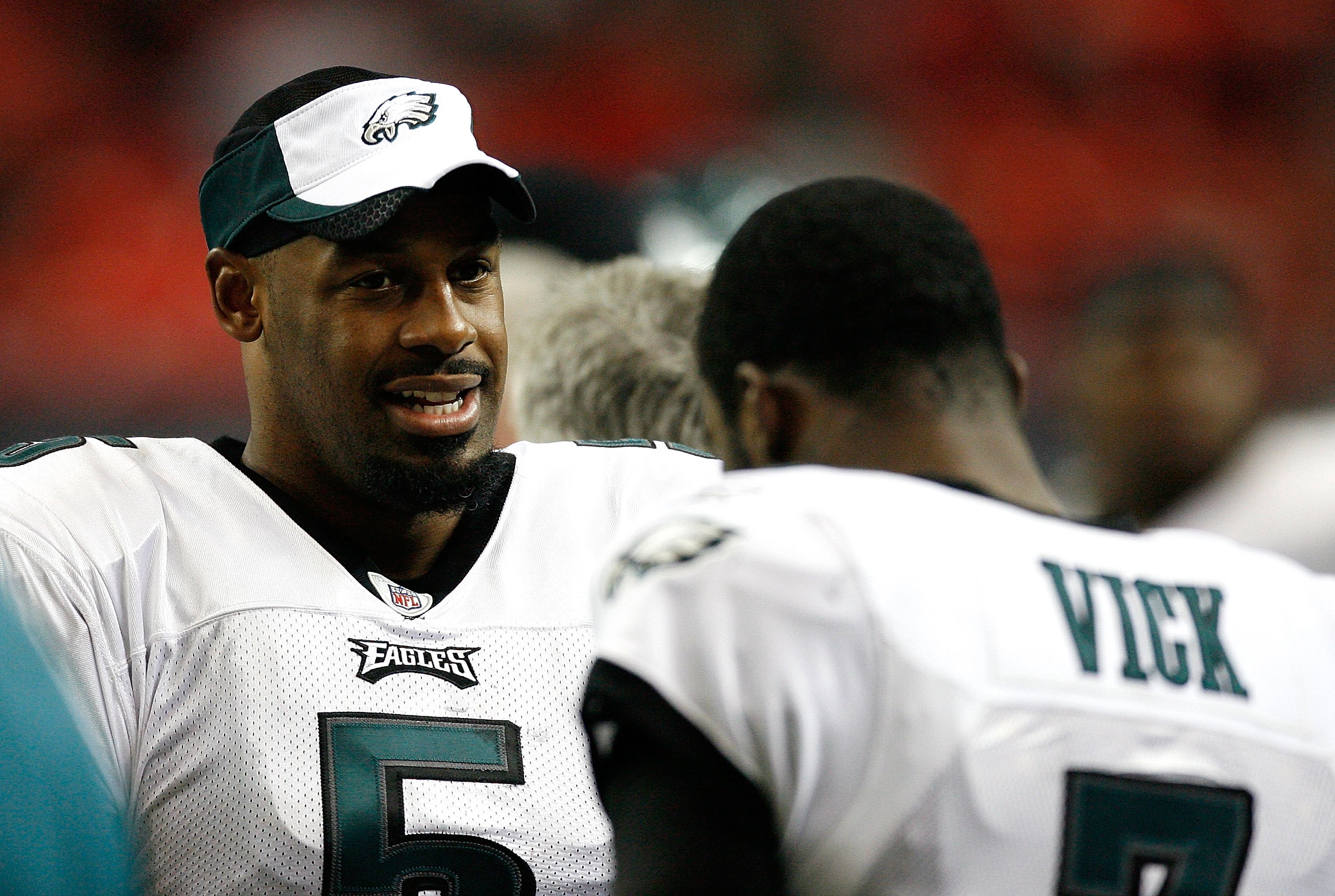 Former Atlanta Falcons and Philadelphia Eagles quarterback Michael Vick  wears one of his special edition New Era hats on sale in the NFL Shop at  the Super Bowl Experience on Thursday, Jan.