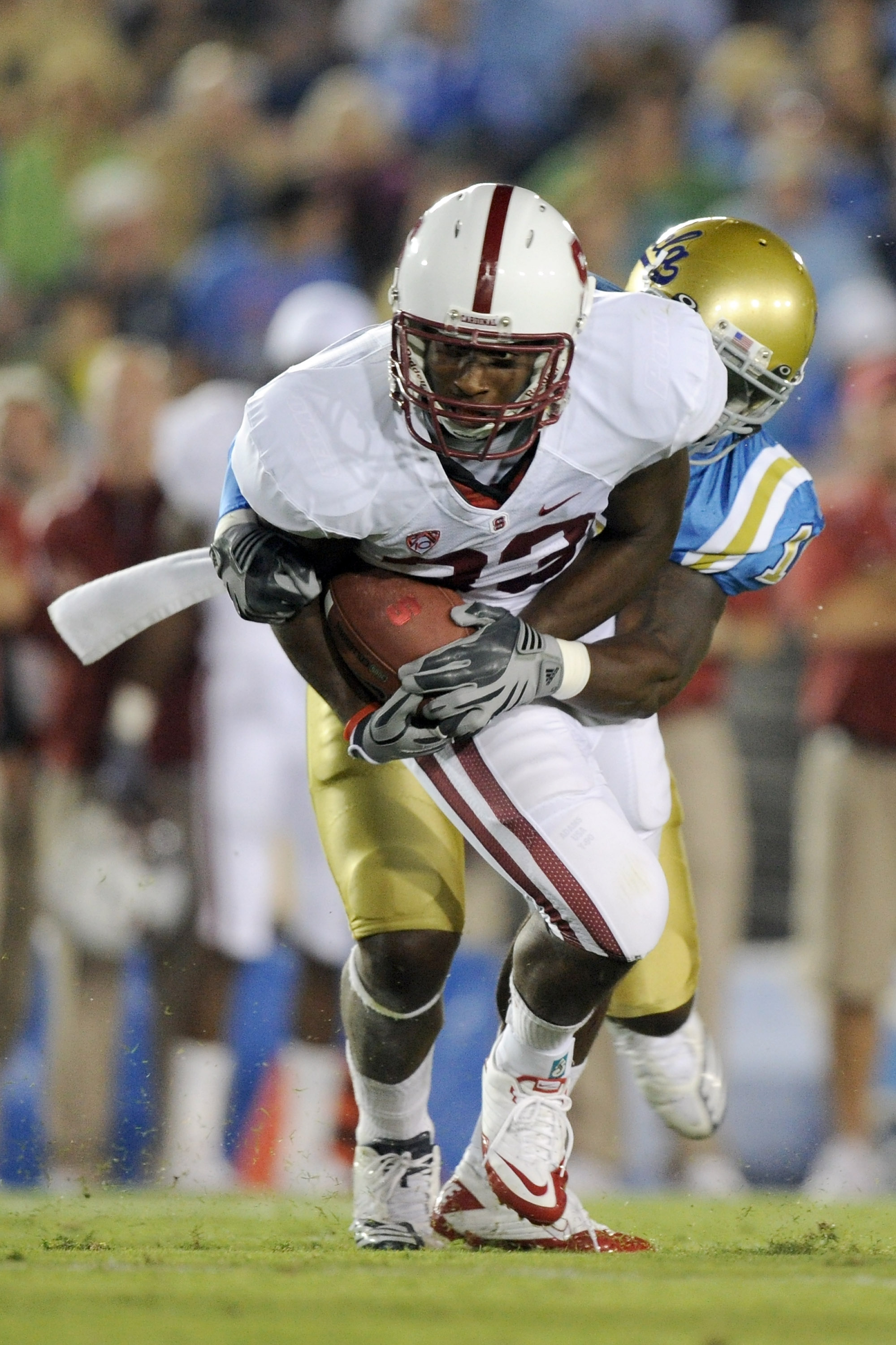 PASADENA, CA - SEPTEMBER 11: Stepfan Taylor #33 of Stanford is tackled by Akeem Ayers #10 of UCLA during the game at the Rose Bowl on September 11, 2010 in Pasadena, California. (Photo by Harry How/Getty Images)
