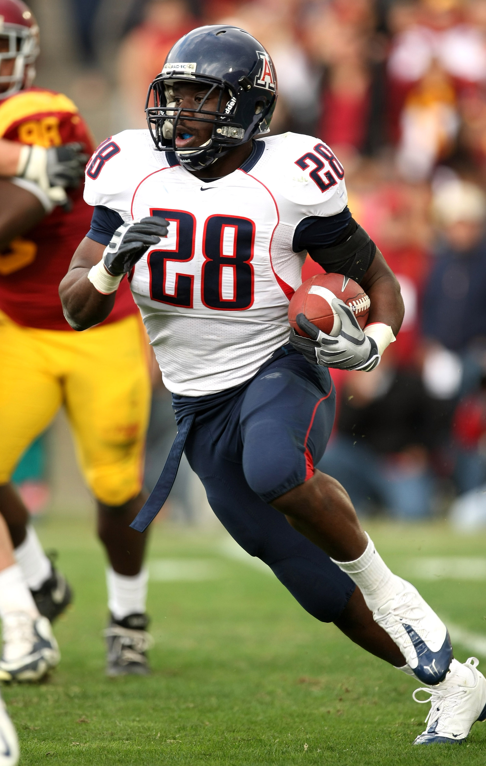 LOS ANGELES - DECEMBER 5: Running back Greg Nwoko #28 of the Arizona Wildcats carries the ball against the USC Trojans on December 5, 2009 at the Los Angeles Coliseum in Los Angeles, California. (Photo by Stephen Dunn/Getty Images)