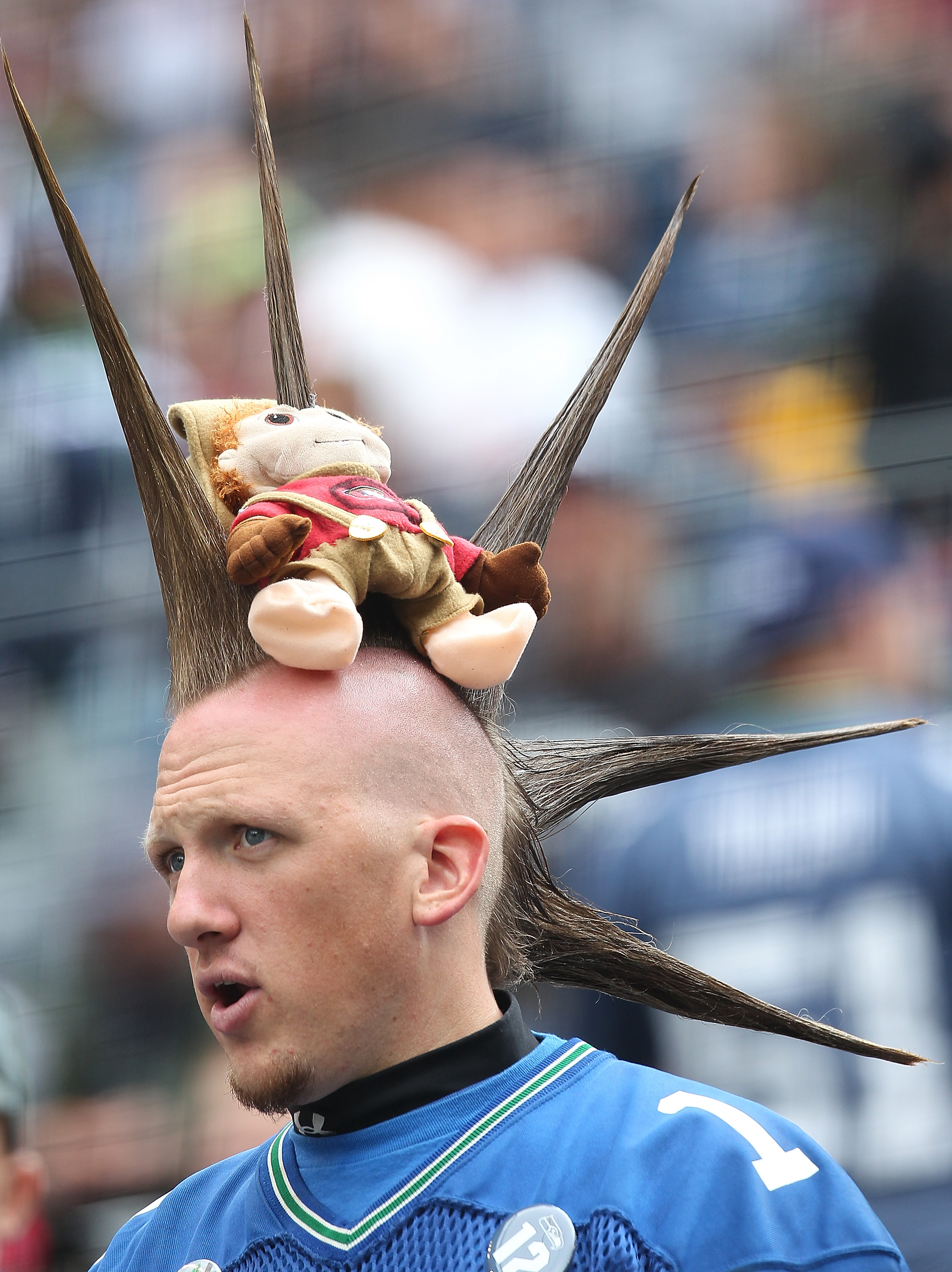 SEATTLE - SEPTEMBER 12:  A fan of the Seattle Seahawks wears a 49er doll on his head, pierced by a spike of his hair during the NFL season opener against the San Francisco 49ers at Qwest Field on September 12, 2010 in Seattle, Washington. The Seahawks def