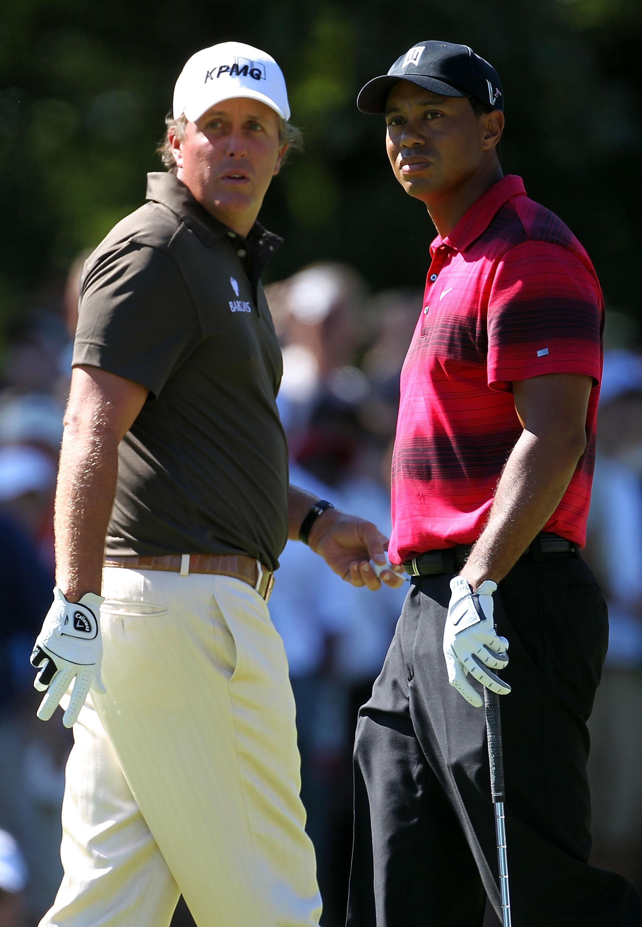 LEMONT, IL - SEPTEMBER 12:  Phil Mickelson and Tiger Woods pass each other by on the second hole during the final round of the BMW Championship at Cog Hill Golf & Country Club on September 12, 2010 in Lemont, Illinois.  (Photo by Jamie Squire/Getty Images