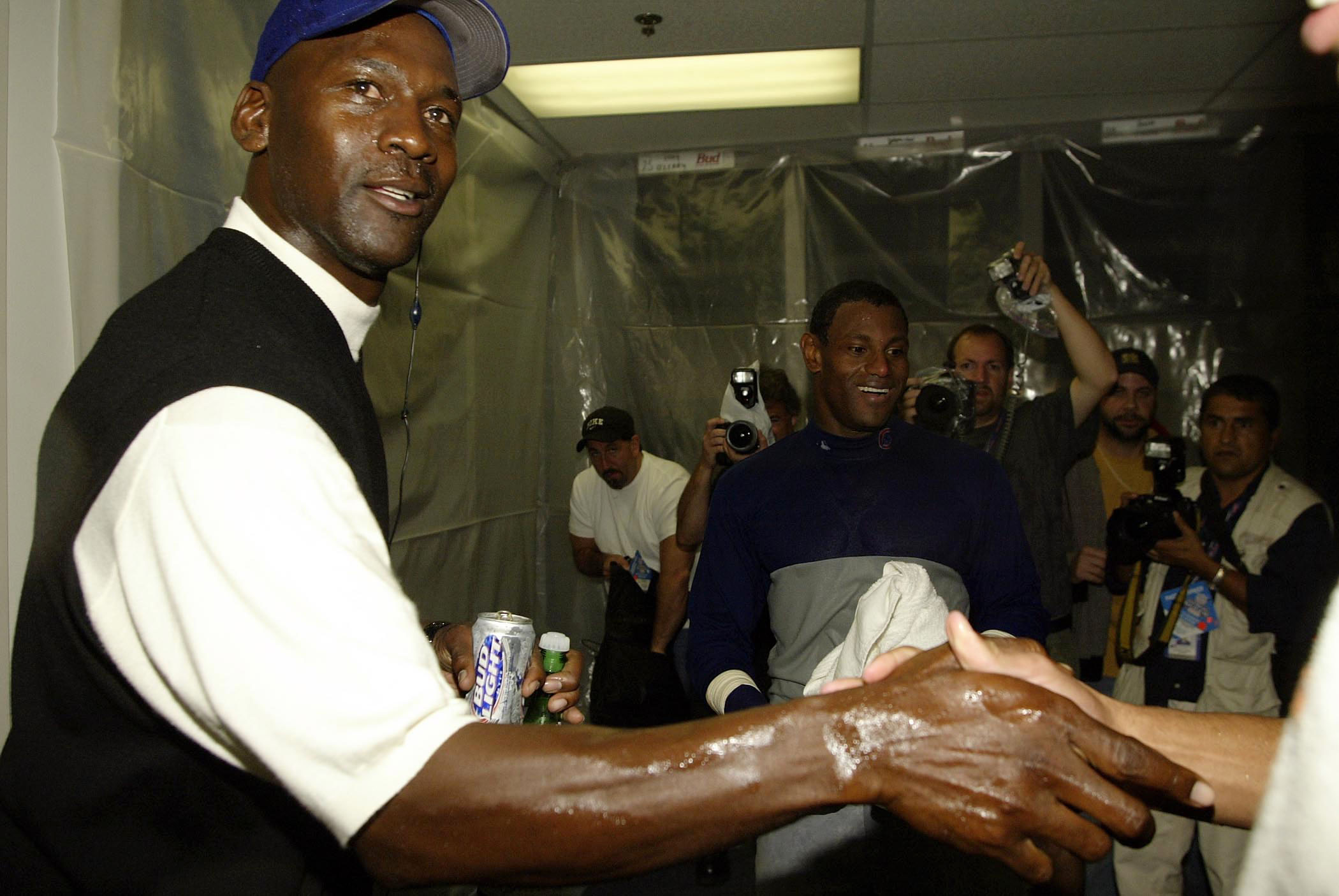 ATLANTA - OCTOBER 5:  Former Chicago Bull Michael Jordan celebrates with Sammy Sosa #21 and the Chicago Cubs in the locker room after the Chicago Cubs defeated the Atlanta Braves 5-1 during Game 5 of the National League Division Series between the Chicago