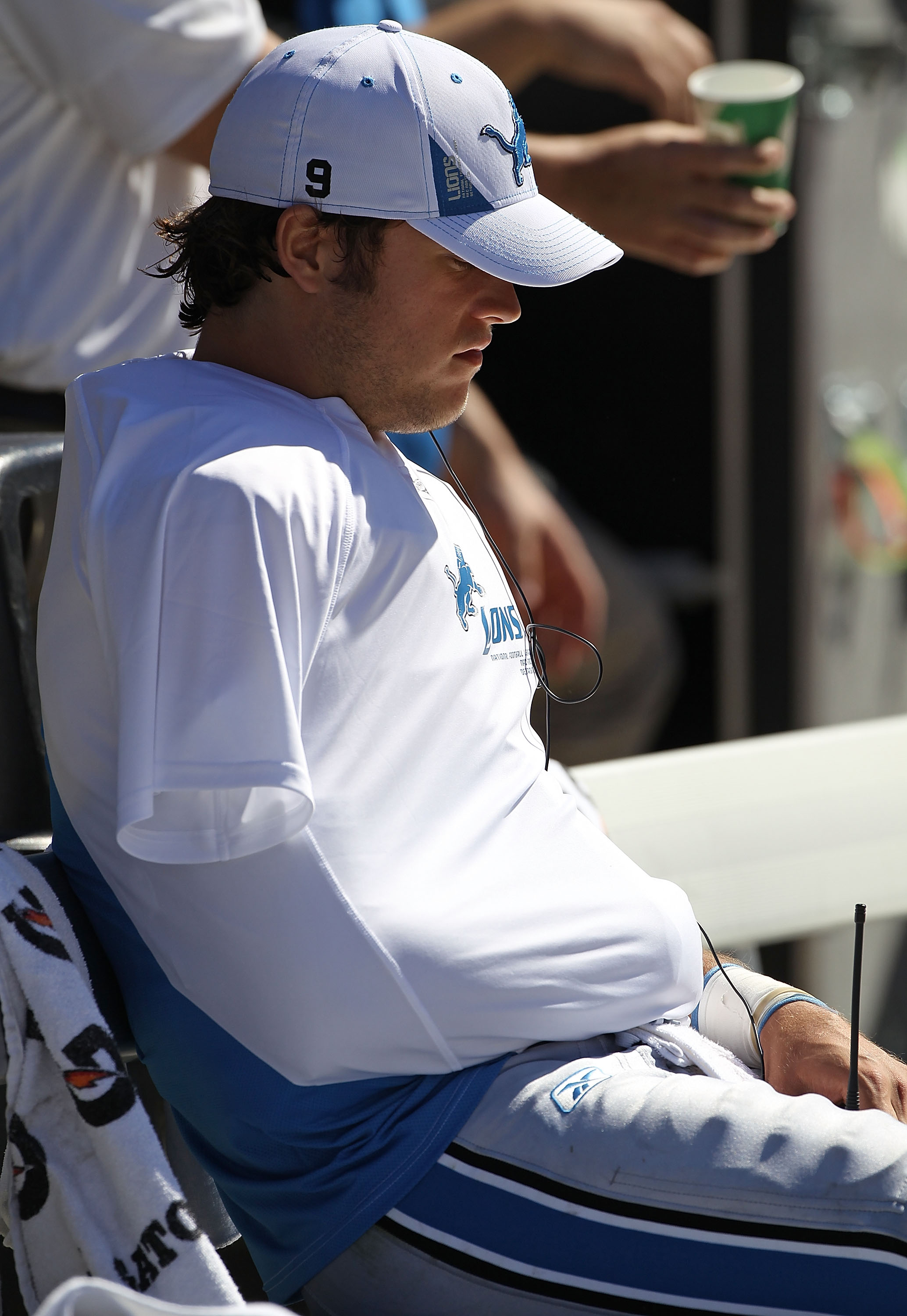 Detroit Lions quarterback Matthew Stafford wears a baseball cap sitting on  the bench after being replaced in the fourth quarter with a large lead over  the Denver Broncos at Sports Authority Field