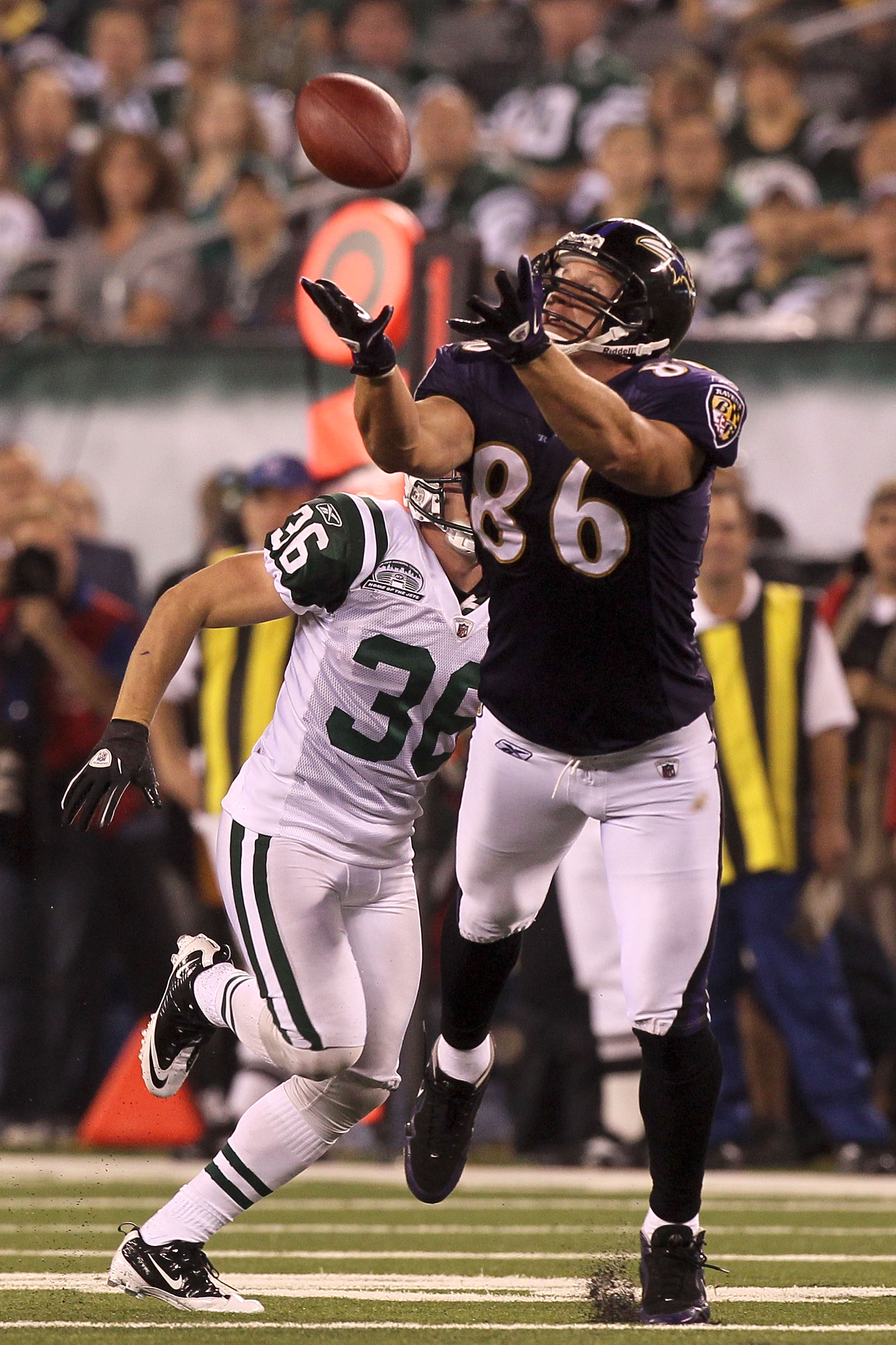 EAST RUTHERFORD, NJ - SEPTEMBER 13:  Todd Heap #86 of the Baltimore Ravens catches a pass over Jim Leonhard #36 of the New York Jets during their home opener at the New Meadowlands Stadium on September 13, 2010 in East Rutherford, New Jersey.  (Photo by J